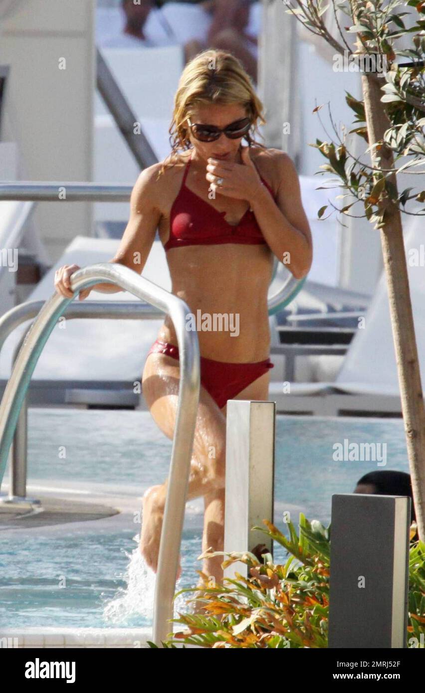 Exclusive!! Kelly Ripa shows off her toned physique in a teeny red bikini  as she relaxed at the pool of an exclusive Miami hotel with her husband  Marc Consuelos and children Michael,