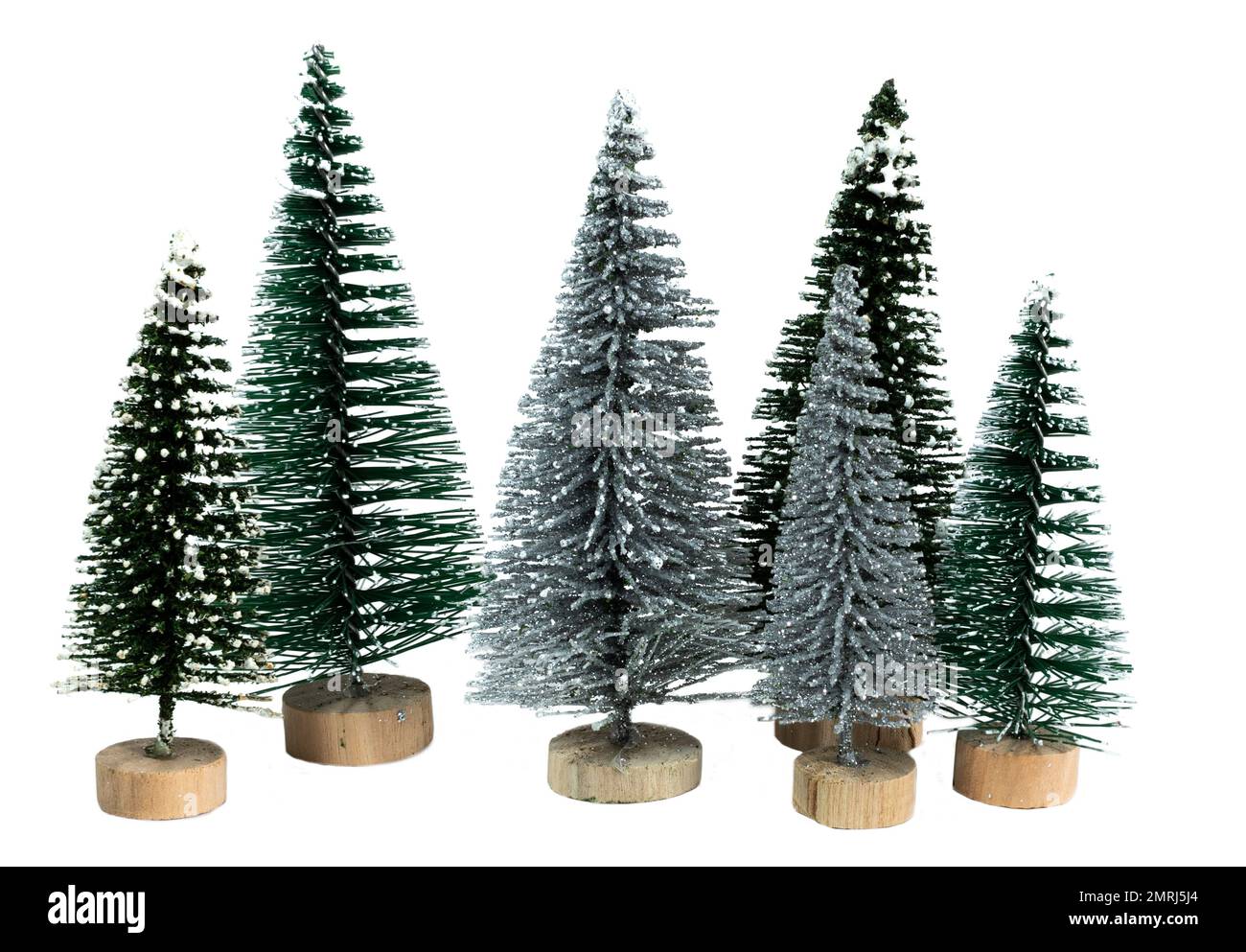 Small and artificial Christmas trees isolated on a white background ...