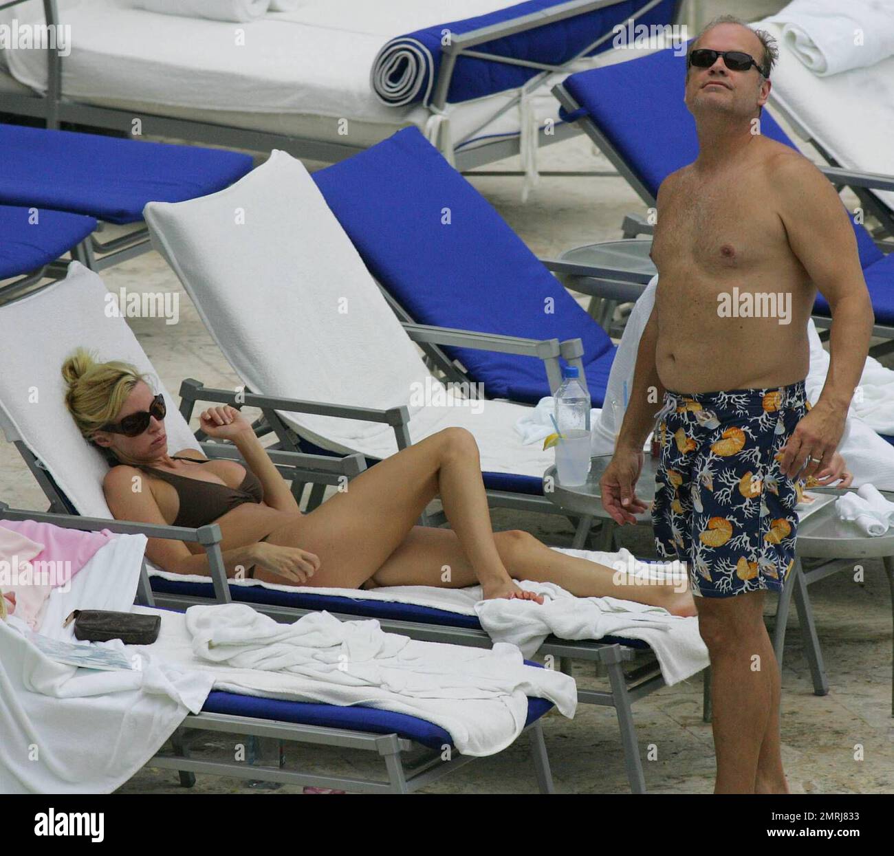Exclusive!! Kelsey Grammer with wife Camille, daughter Mason and friends relax poolside at a Miami Hotel. After swimming lessons, his young daughter had a stumble and after Kelsey dried her eyes her she was taken indoors to leave mum and dad to sunbathe. 6/6/05All   "" Stock Photo
