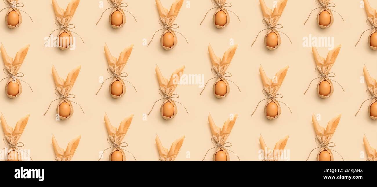 Many Easter egg with bunny ears on beige background. Pattern for design Stock Photo
