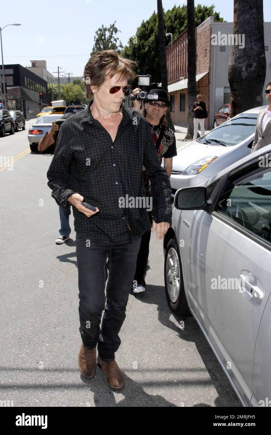 Actor Kevin Bacon gets into his Toyota Prius while out running errands