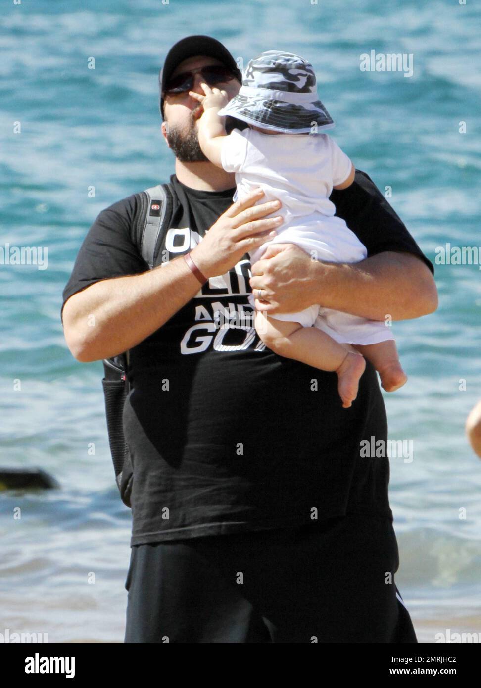 'Zookeeper' star Kevin James spends a day on the beach with his family while on holiday for Thanksgiving. James and his wife Steffiana de la Cruz spent the day on the beach with their daughter Sienna-Marie, 6, and newborn son Kannon Valentine, who was born on April 24 of this year. A proud dad, James carried around little Kannon who wore a hat to protect from the sun and later buried Sienna-Marie in the sand. Steffiana also took a surfside stroll with Sienna, who looked to have a great time swimming in the Pacific. Ever gracious, Kevin also took time to sign autographs and talk with some young Stock Photo