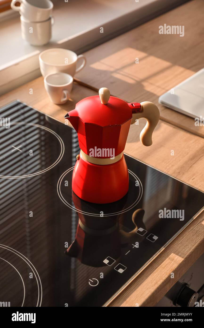 Geyser coffee maker on electric stove in kitchen Stock Photo Alamy