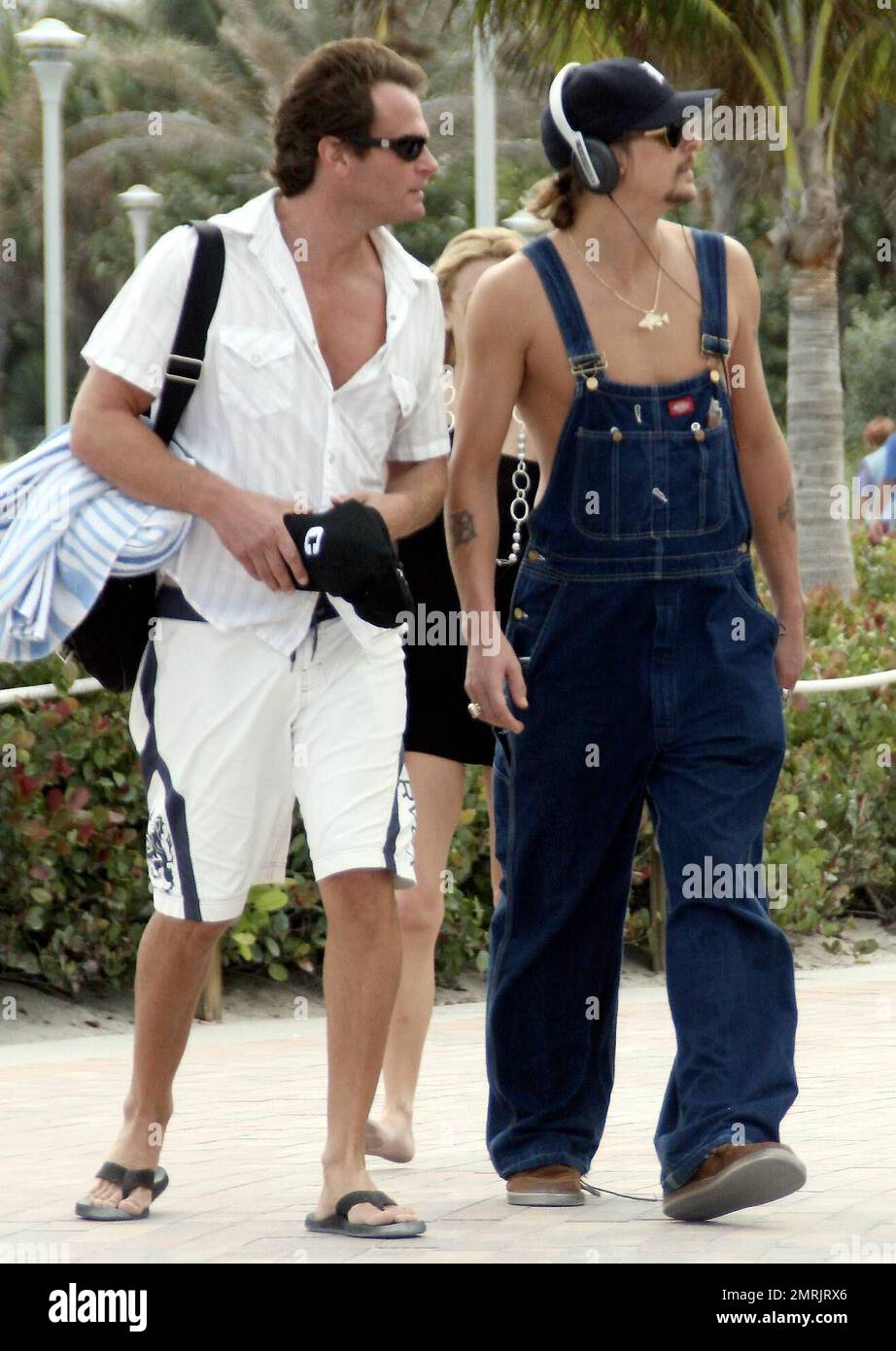 Kid Rock takes a stroll with Rande Gerber before borrowing an un-identified girl's handbag during Superbowl Weekend. Miami, FL 2/3/07. Stock Photo