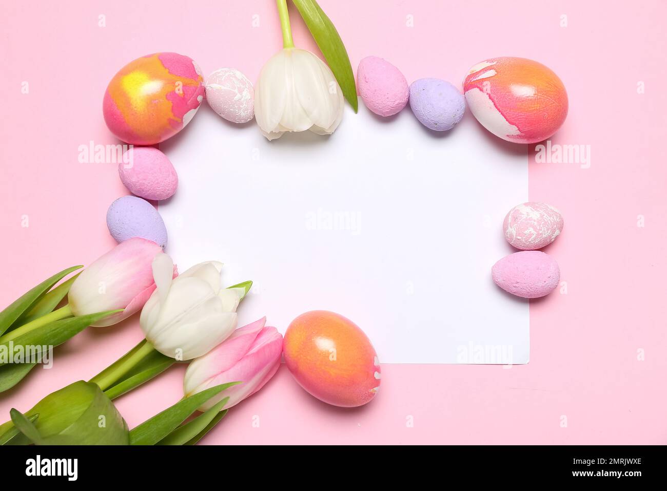 Composition with blank card, painted Easter eggs and tulip flowers on ...