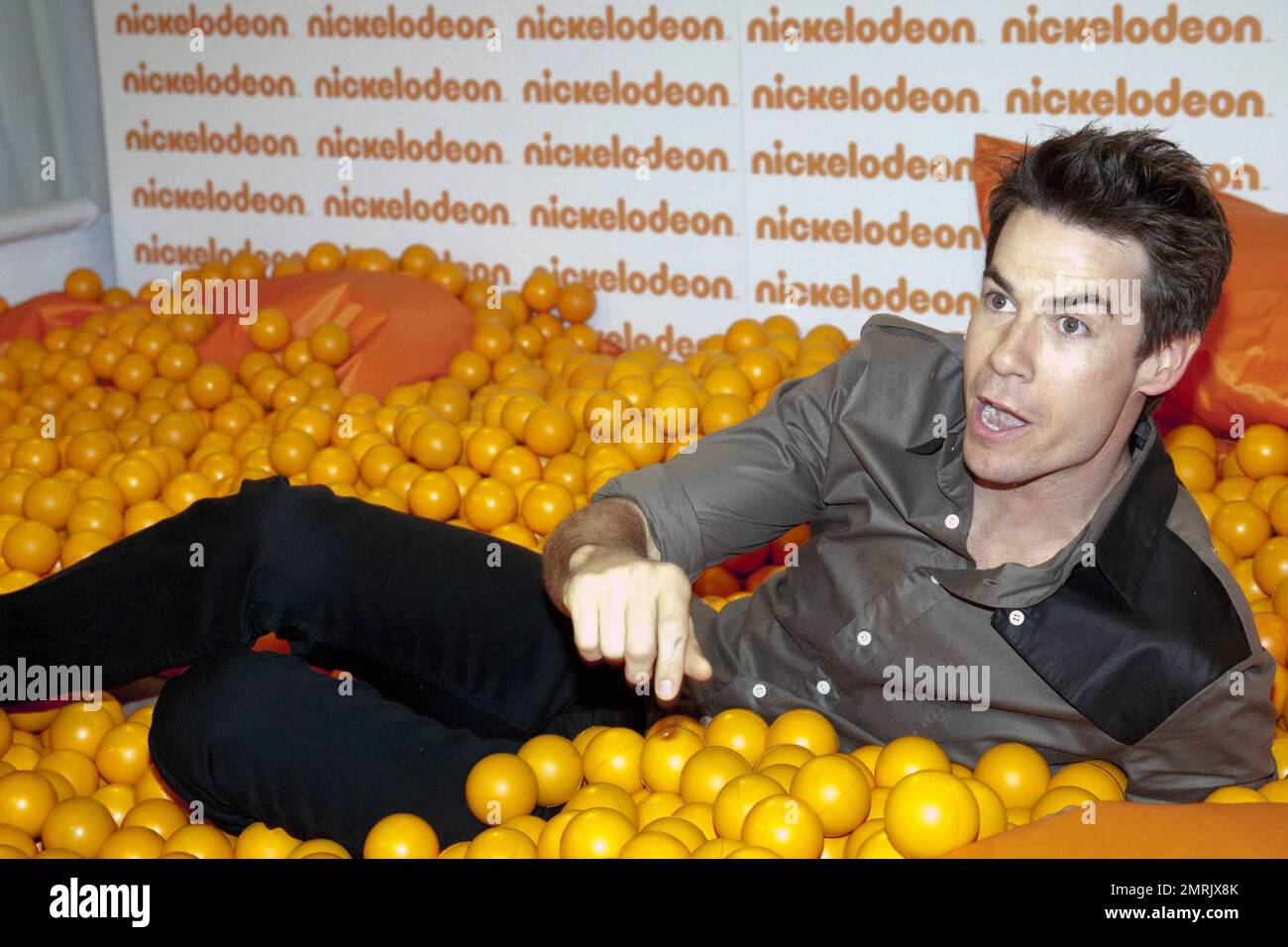 Host of Nickelodeon Australia's Kids Choice Awards 2010, US actor Jerry Trainor clowns around in a ball pit with Miss Singapore finalist Karen Wong prior to the event. Sydney, Australia. 10/8/10. Stock Photo