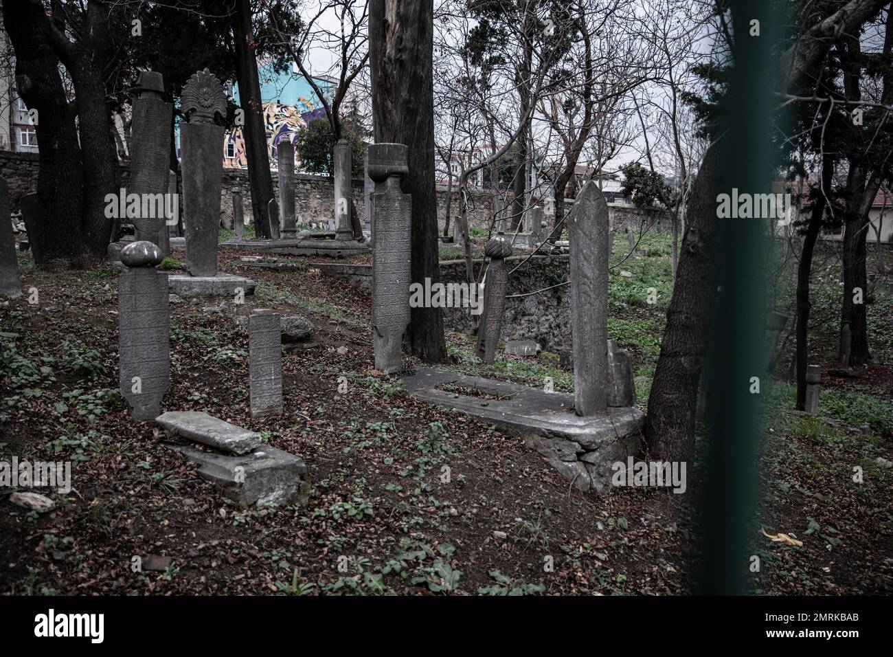 Graves seen behind the iron bars. It is seen that the 400-year-old historical cemetery in Kadikoy is neglected. The Ayrilik Cesme Cemetery, which is the last part of the Karacaahmet Cemetery in Istanbul Uskudar and contains the graves of the names who served in the Ottoman Palace, has turned into ruins. It is known that the burial process in the cemetery, where the first burials were made 400 years ago, continued until the beginning of the 20th century. The cemetery, where most of the tombstones were destroyed, some of the heads fell off, and in some places the stones were planted collectively Stock Photo