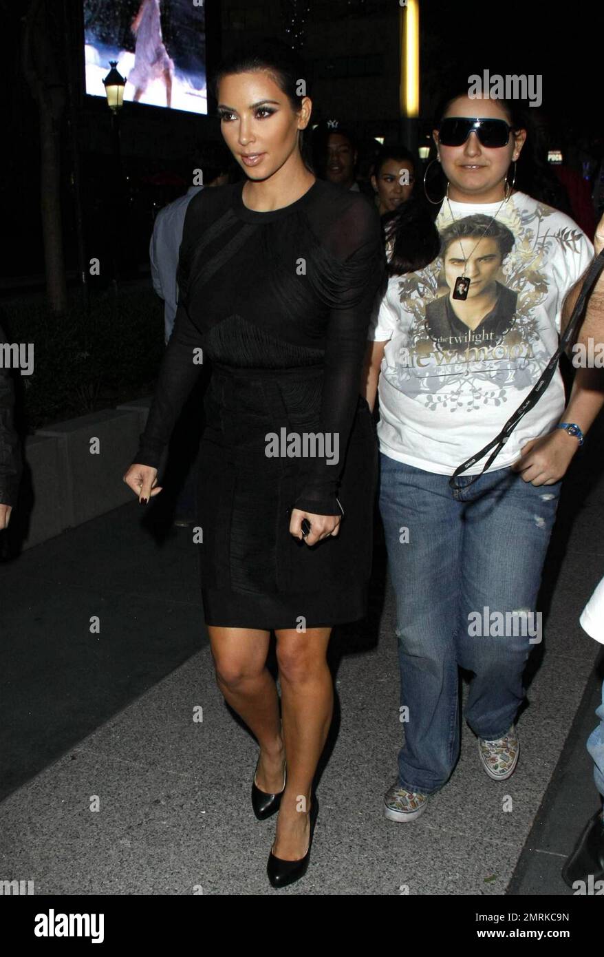 Kim Kardashian flashes a peace sign and signs autographs for fans as