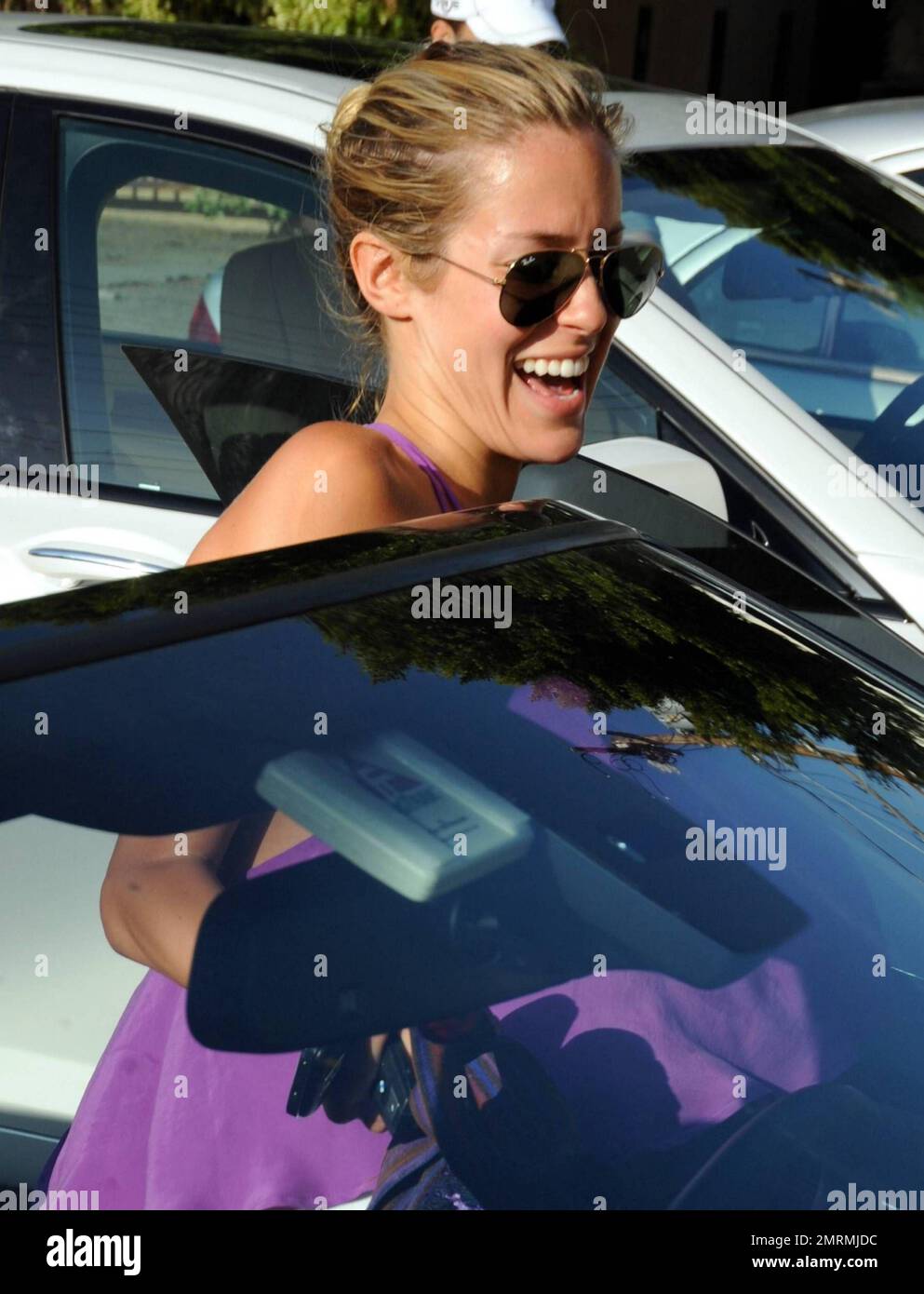 "The Hills" star Kristin Cavallari wears a purple top paired with a