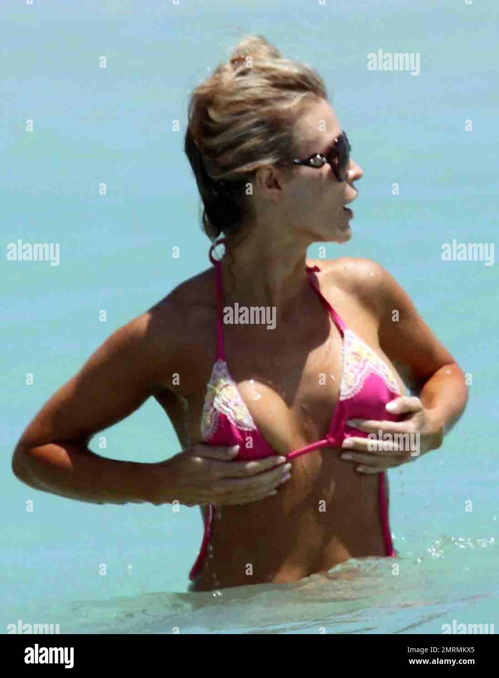 EXCLUSIVE!! Beautiful model, Joanna Krupa, is rescued by her fiancŽ Romain  Zago when her pink bikini top came undone during a dip in the ocean. Zago  helped her to do the bikini