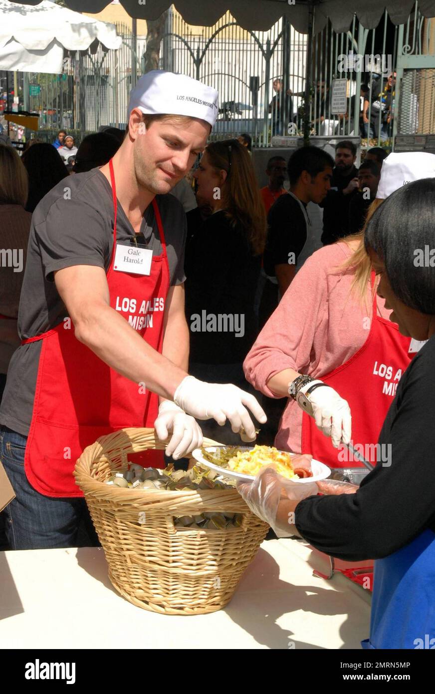 Gale Harold volunteers time for Easter at the Los Angeles (LA) Mission to help serve meals to the homeless and less fortunate, where meals, new sneakers (etnies) and toys (JAKKS Pacific) were donated in Los Angeles, CA. 4/2/10. Stock Photo