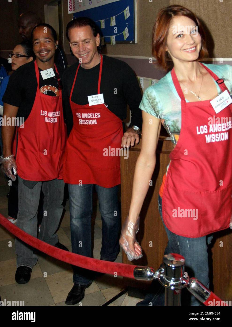 Robert Giardina, DJ Verrett and Katie Amanda Keane participate in the Los Angeles Mission Good Friday Event that features hundreds of volunteers serving the homeless. The event also included a foot washing tent and a shoe fitting area. Los Angeles, CA. 4/10/09. F Stock Photo
