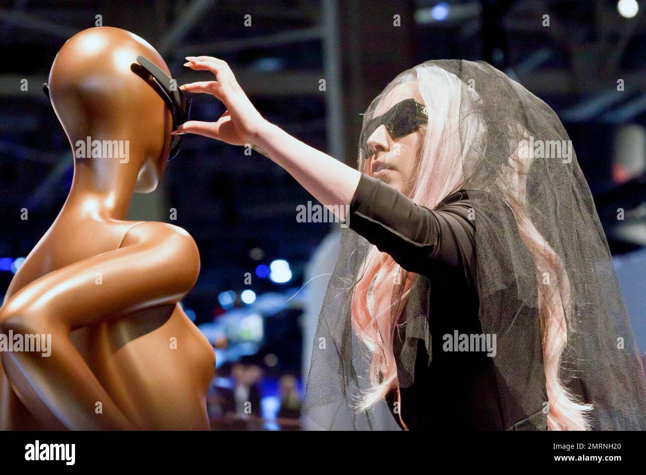 Lady Gaga wears a black veil, Chanel sunglasses and a corset over