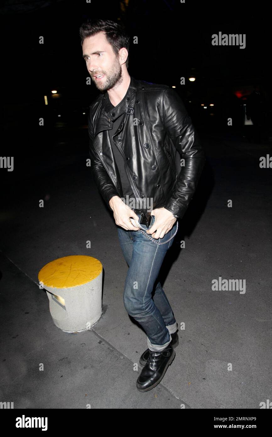 Adam Levine wearing tight pinch rolled jeans and a leather jacket for his  trip to the Staples Center to watch the Utah Jazz verses the Los Angeles  Lakers basketball game. Los Angeles,