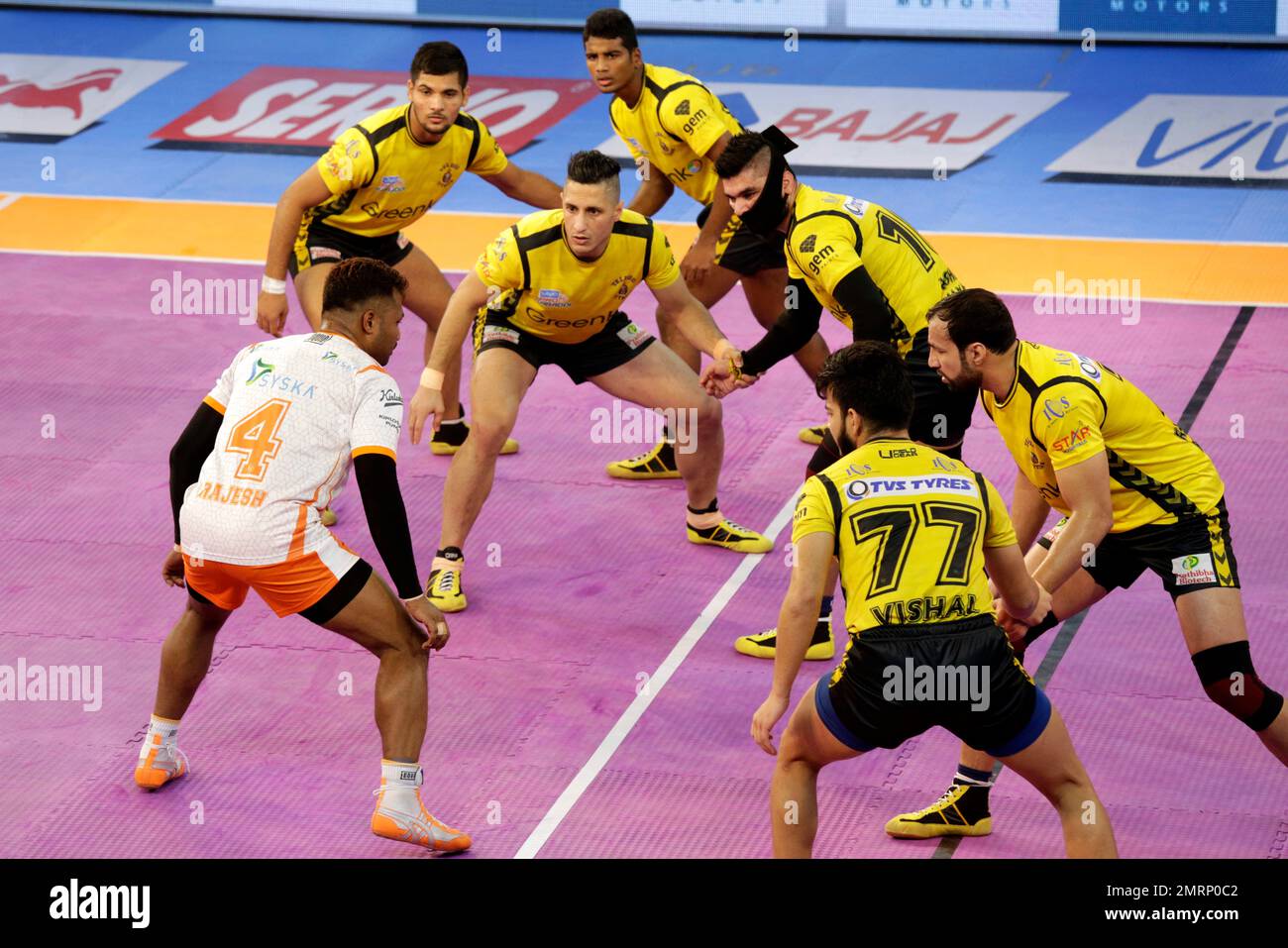 Players of Puneri Paltan pin down Monu Goyat, in green jersey, of Patna  Pirates during their Vivo Pro Kabaddi league match in Mumbai, India,  Tuesday, Oct. 24, 2017. (AP Photo/Rafiq Maqbool Stock