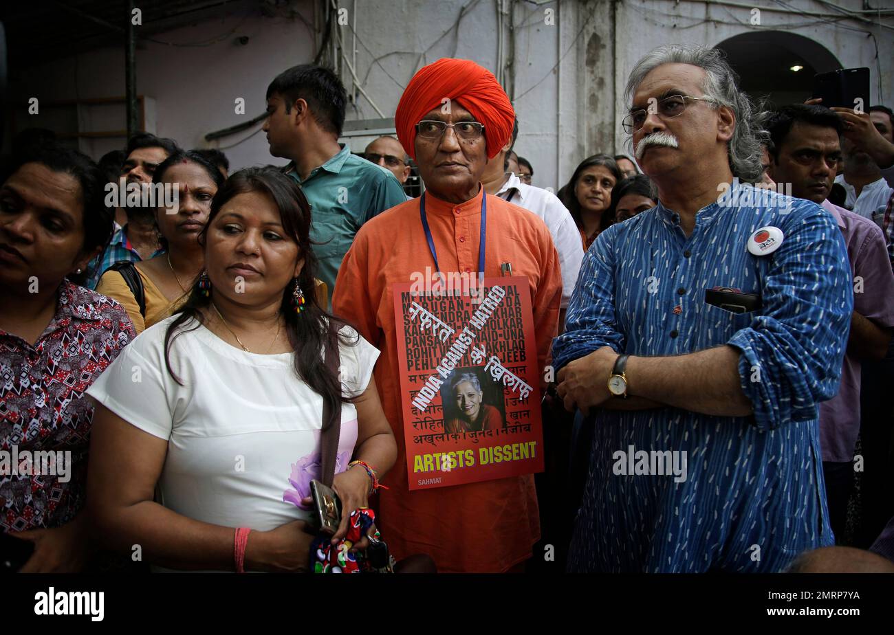 Social activist Swami Agnivesh, center in saffron robe, wears a placard as  he joins a protest meeting by journalists and members of civil society  against the killing of Indian journalist Gauri Lankesh