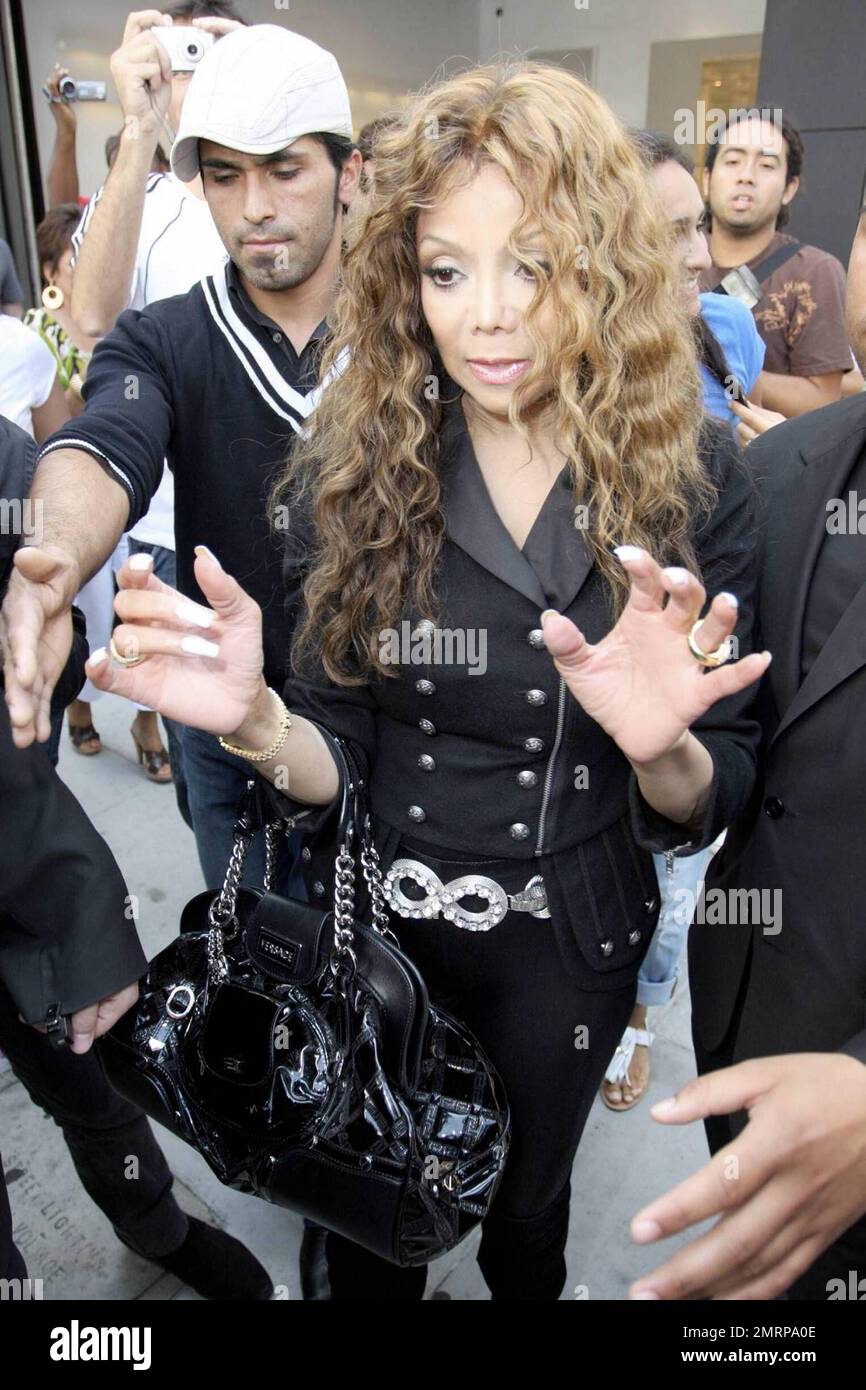 Latoya Jackson is protected by bodyguards as she leaves the Chanel