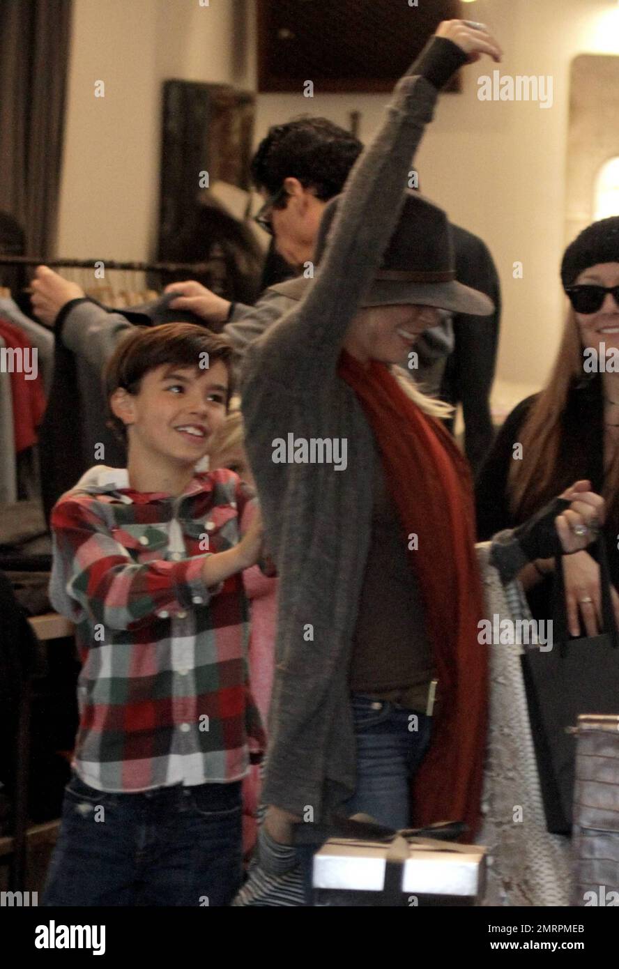 Singer LeAnn Rimes and husband, actor Eddie Cibrian, along with his sons Mason, 7, and Jake, 4, were seen shopping at the Malibu Country Mart. The country superstar wore a brown hat, brown top, blue jeans with black knee high boots and kept it warm with a grey sweater and a rusty colored scarf. 29 year old Rimes was seen joking around and being playful with her husband's sons giving each one hugs and even picking up Jake at one point. The family who appeared to be having a great time together eventually headed out in their black Porsche. Malibu, CA. 11th December 2011. Stock Photo