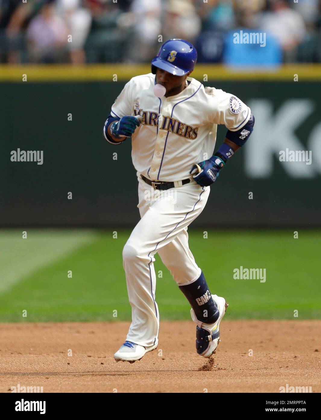 Seattle Mariners' Robinson Cano blows a bubble with his gum as he rounds  the bases after hitting a solo home run during the first inning of a  baseball game against the Cleveland
