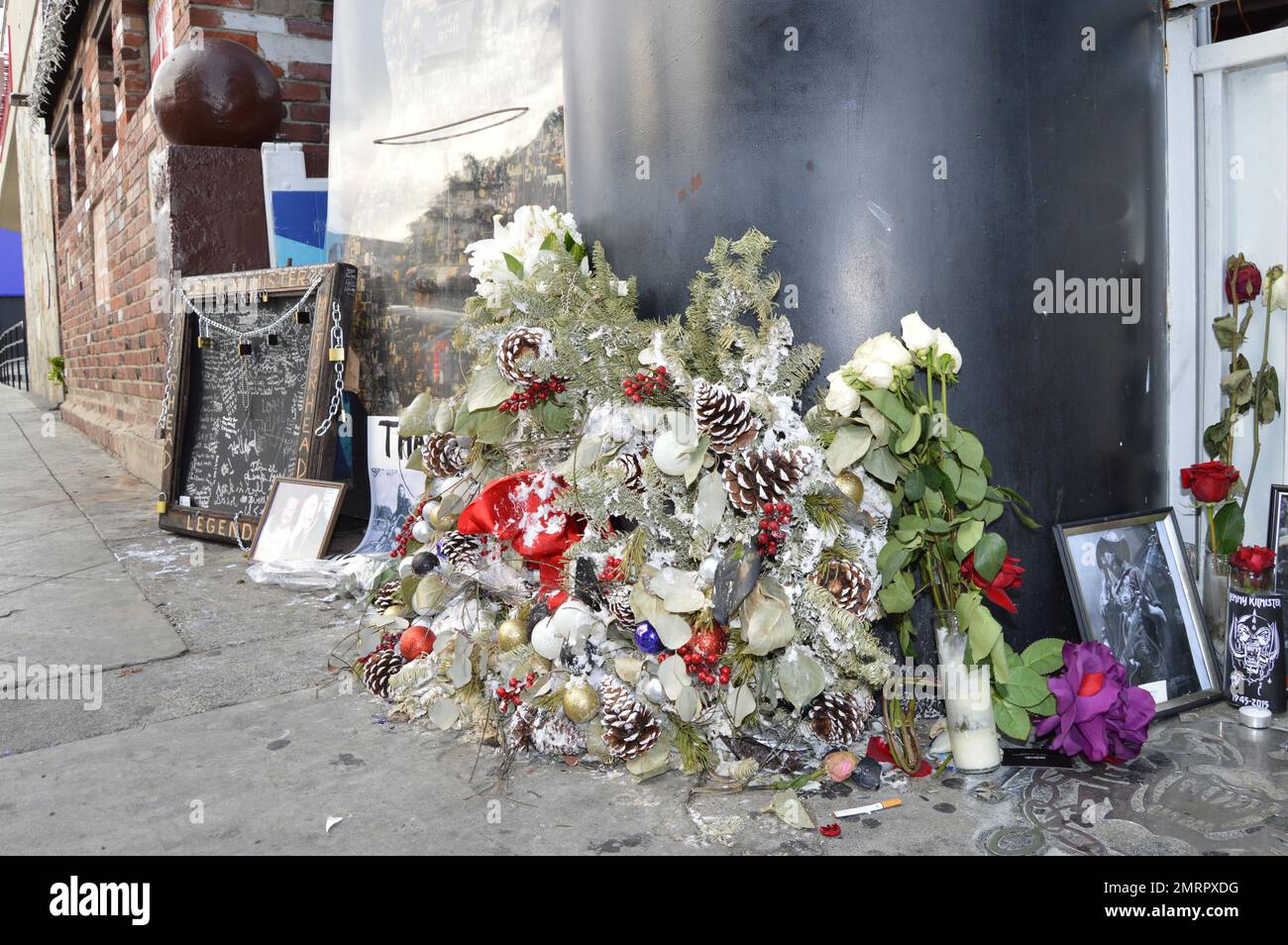 General view of tributes left outside the Rainbow Bar & Grill on the Sunset Strip in honor of Lemmy from the rock band Motorhead, in West Hollywood, CA. Also pictured is a touching note rocker Dave Grohl penned for his friend. Stock Photo