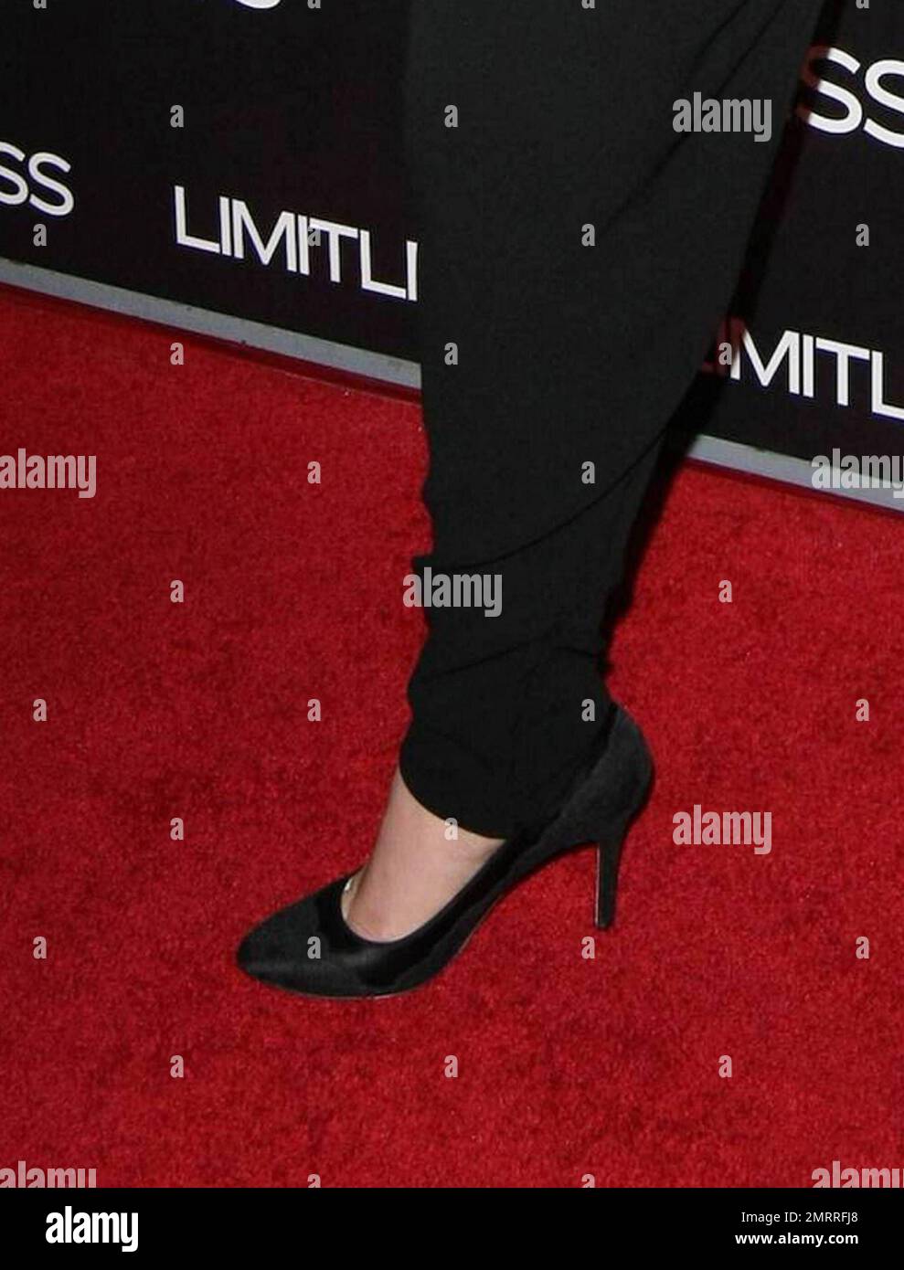 In trendy tapered black trousers tucked in to her black high heels and  suspenders Abbie Cornish poses for photographers on the red carpet at the  premiere of "Limitless" held at ArcLight Cinemas