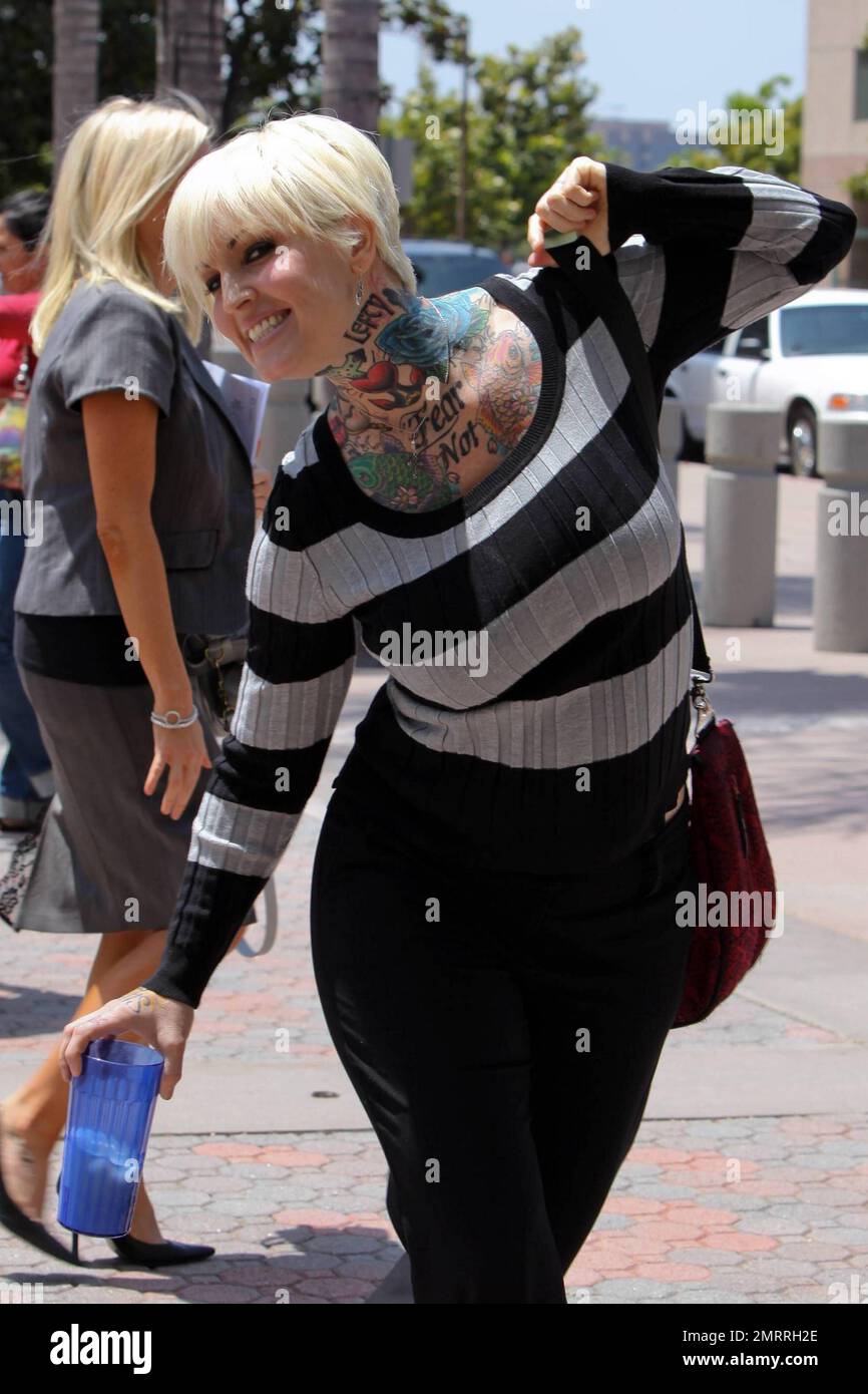 EXCLUSIVE!! Showing off a tattoo on her upper chest that reads 'Fear Not,' Janine Lindemulder, ex-wife of Jesse James, leaves Family Court in Orange County, California after a hearing regarding the custody of their daughter, Sunny. According to reports, the hearing resulted in the judge rejecting Jesse's claim that Lindemulder should be denied visitation because of alleged drug problems. Los Angeles, CA. 6/18/10. Stock Photo