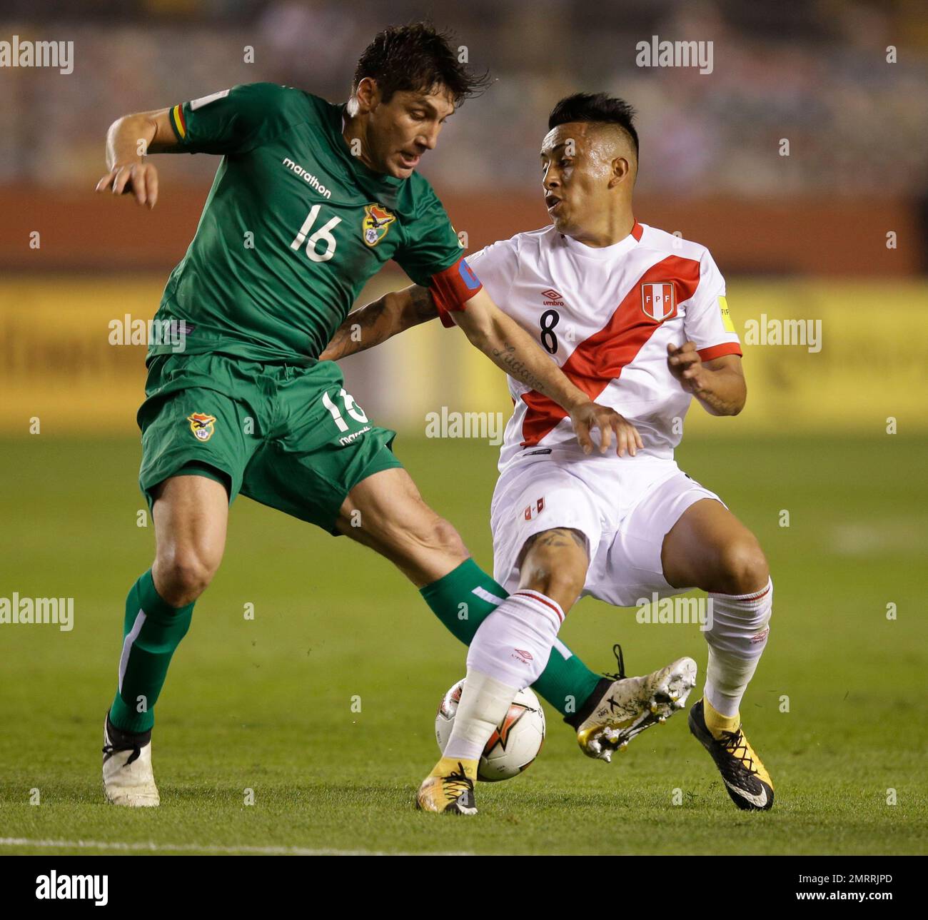 Bolivia's Ronald Raldes, left, fights for the ball with Peru's ...