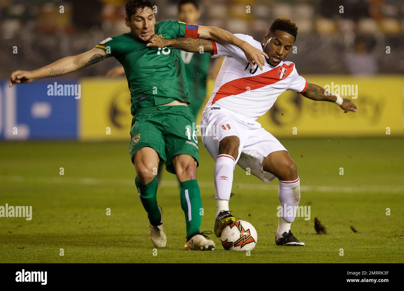 Bolivia's Ronald Raldes, left, fights for the ball with Peru's ...