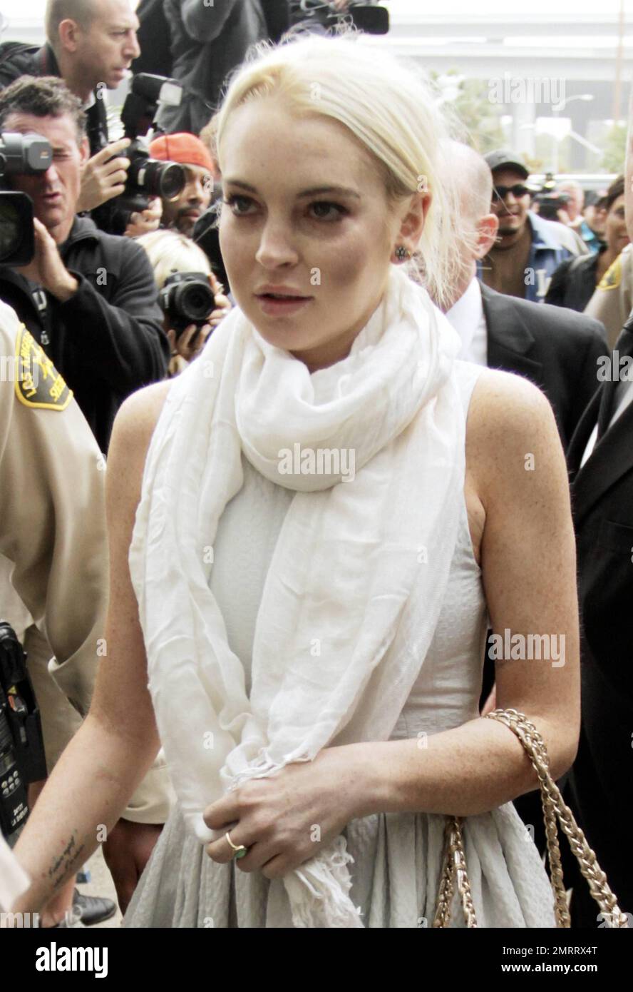 Actress Lindsay Lohan dressed in an all white ensemble arrives at the Los Angeles Municipal Court to face Judge Stephanie Sautener and review the possibility of her probation being revoked. Lohan was reportedly, kicked out of the community service the judge ordered her to complete after failing to report 9 times. The Probation Department was extremely forgiving of Lindsay's absences and reassigning her to the Red Cross but Judge Sautner did not approve of this change yanking Lindsay out of the Red Cross and reassigning her to a morgue. Today's hearing could be tense, due to the judge and Proba Stock Photo