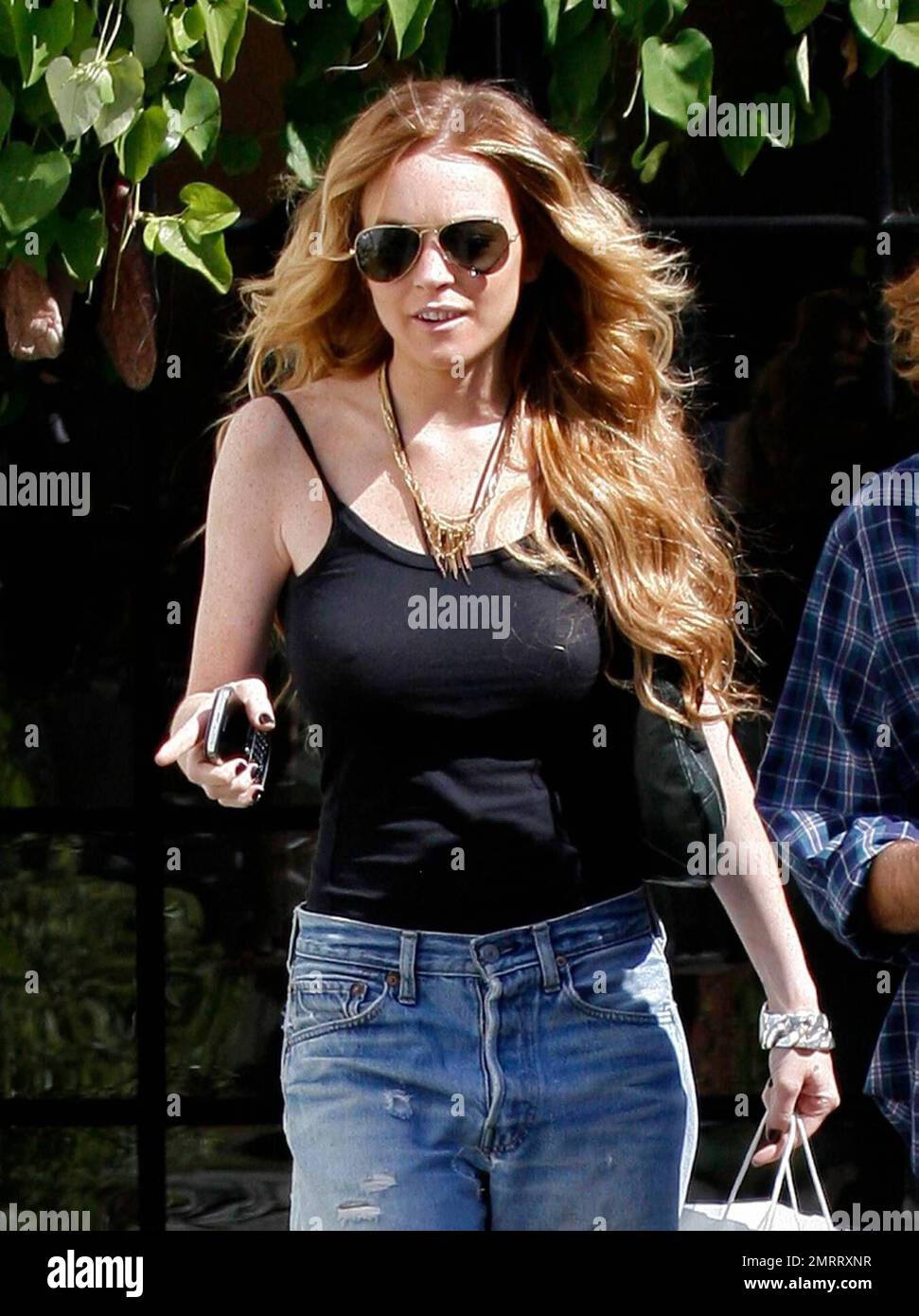 An apparently bra less Lindsay Lohan reveals quite a bit through her