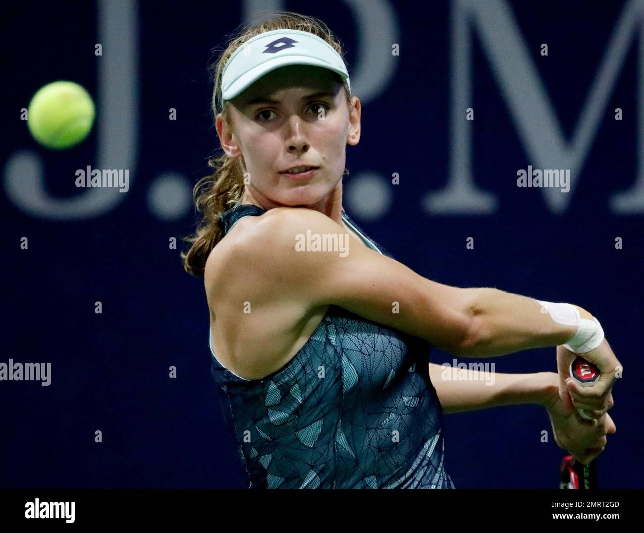 Ekaterina Alexandrova, of Russia, watches the ball before hitting a