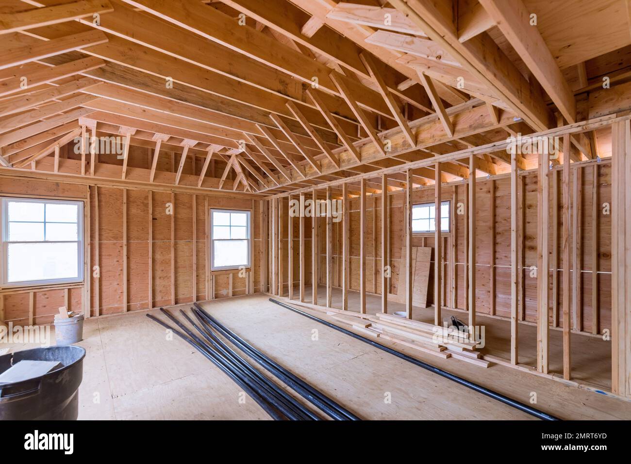 Fragment view beams stick built of new home under construction wood framing beam framework Stock Photo