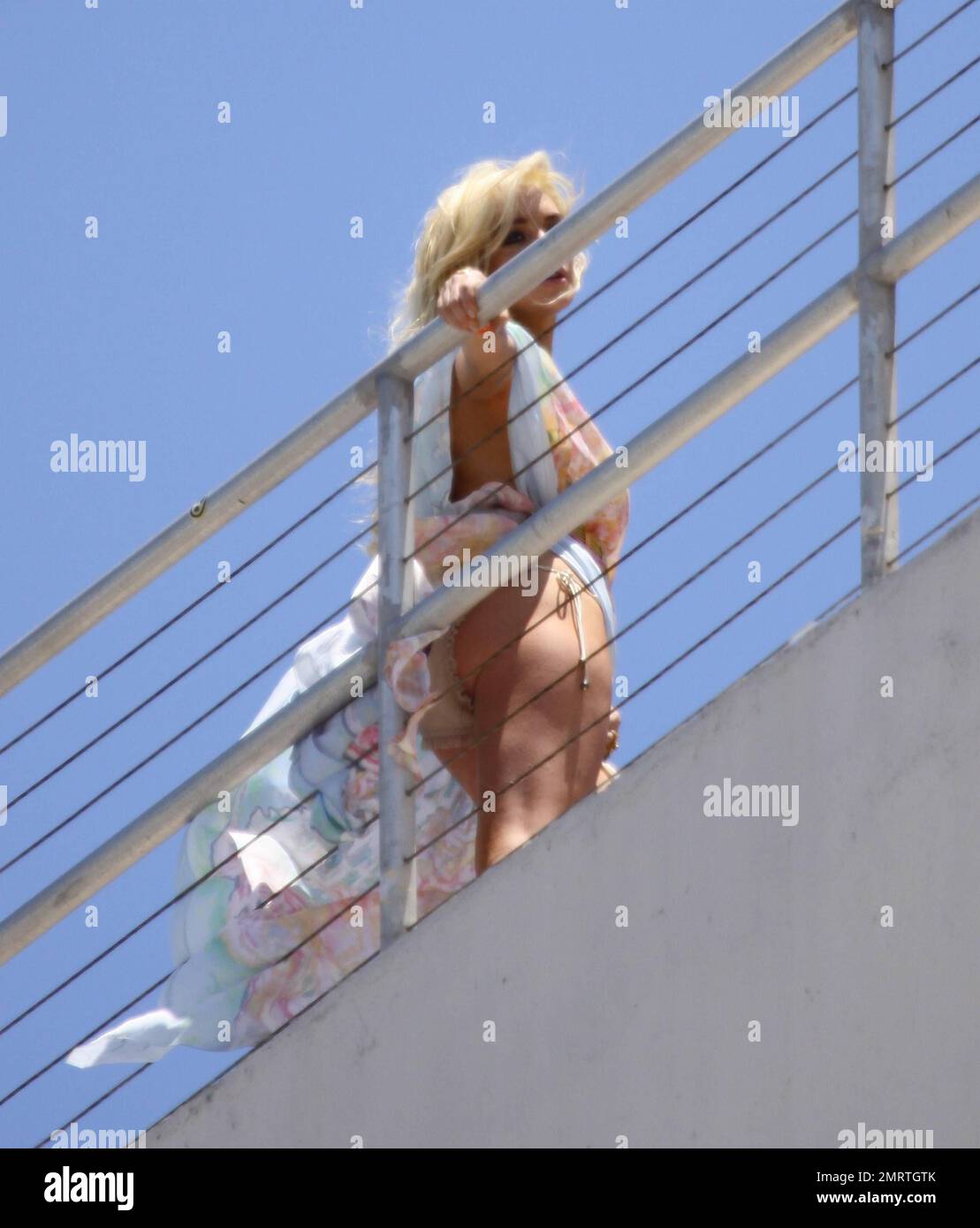 Lindsay Lohan does a Marilyn Monroe-esque photo shoot on the roof of a Miami Beach hotel for Plum TV with her hair and dress blowing up  in the wind, possibly showing more than she intended in a signature Marilyn pose. Lohan's shoot is to go alongside an interview for the show that is due to come out on June 15th, the day before reports say Lohan will have to surrender to authorities.  Miami Beach, FL 5/21/11 Stock Photo