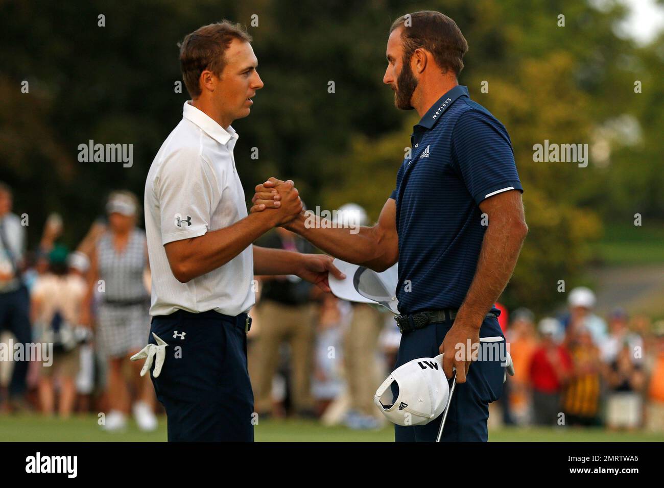 Dustin Johnson, right, shakes hands with Jordan Spieth after winning ...