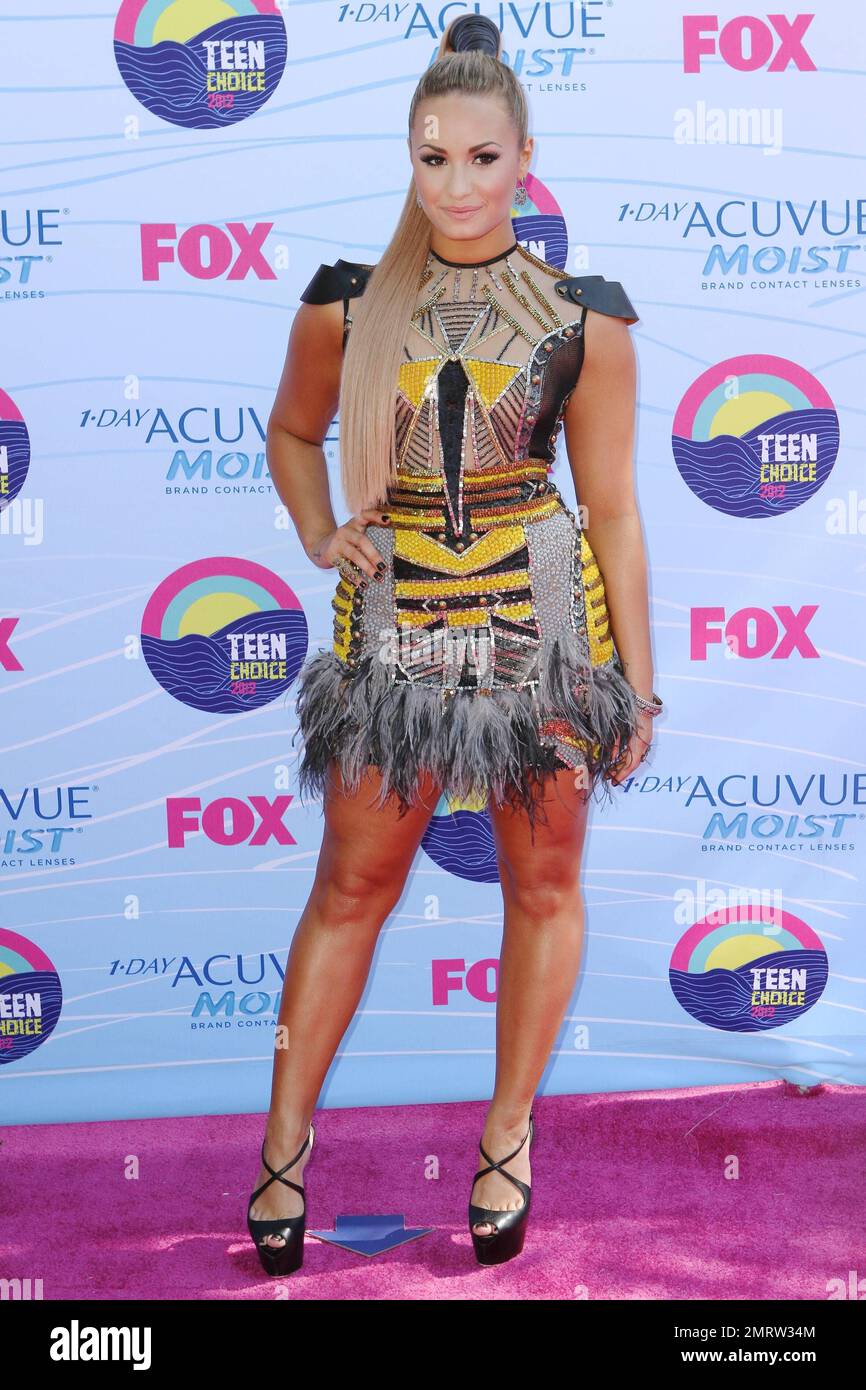 Demi Lovato wears a highly decorated dress complete with feathers at the  2012 Teen Choice Awards at the Gibson Amphitheatre. Los Angeles, CA. 22nd  July 2012 Stock Photo - Alamy