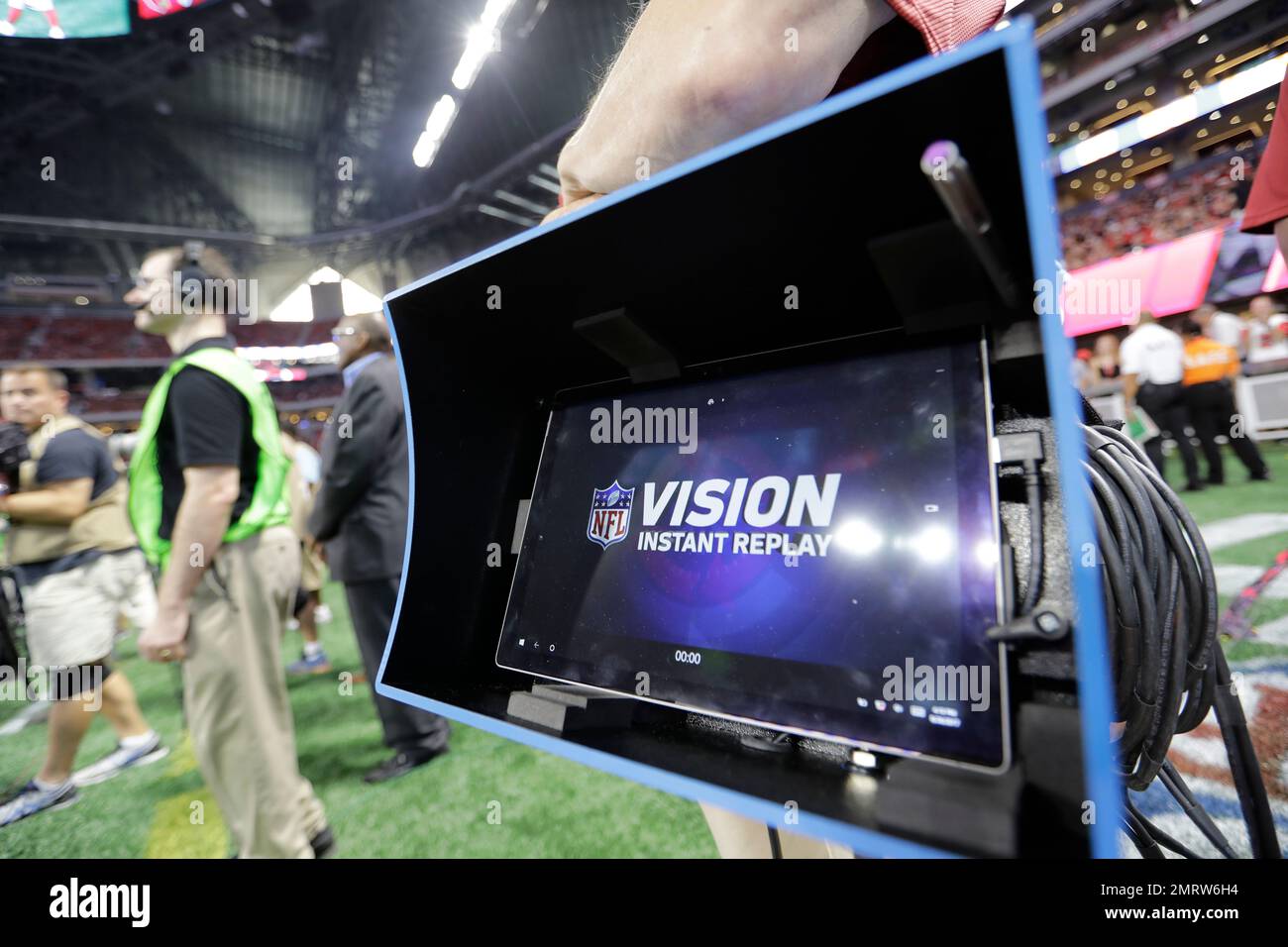 An official holds a Microsoft Surface tablet for instant replay during the  first half of an NFL football game between the Atlanta Falcons and the Arizona  Cardinals, Saturday, Aug. 26, 2017, in