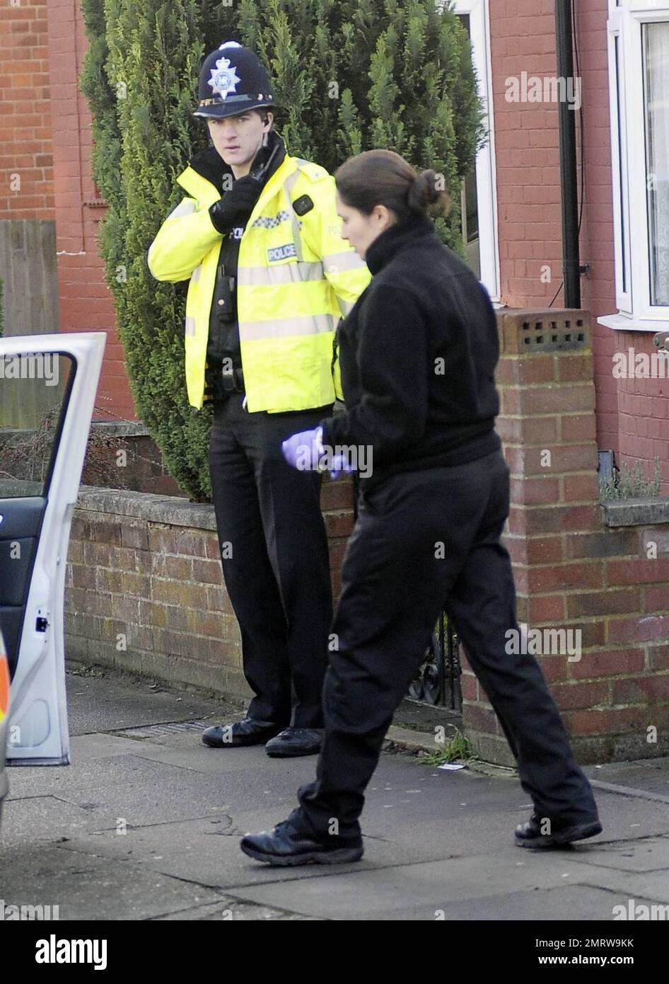 Police stand guard while neighbors and reporters gather at the Luton home where Stockholm suicide bomber suspect Taimour Abdulwahab al-Abdaly is believed to have resided prior to December 11th, the day when two bombs were detonated in Stockholm, Sweden, the second of which killed the suspected bomber who has yet to be identified.  Police searched the Luton home after reportedly obtaining a search warrant under the Terrorism Act 2000, and according to reports police have said that no hazardous materials have been found and no arrests made. During the search a terrorist officer was seen removing Stock Photo