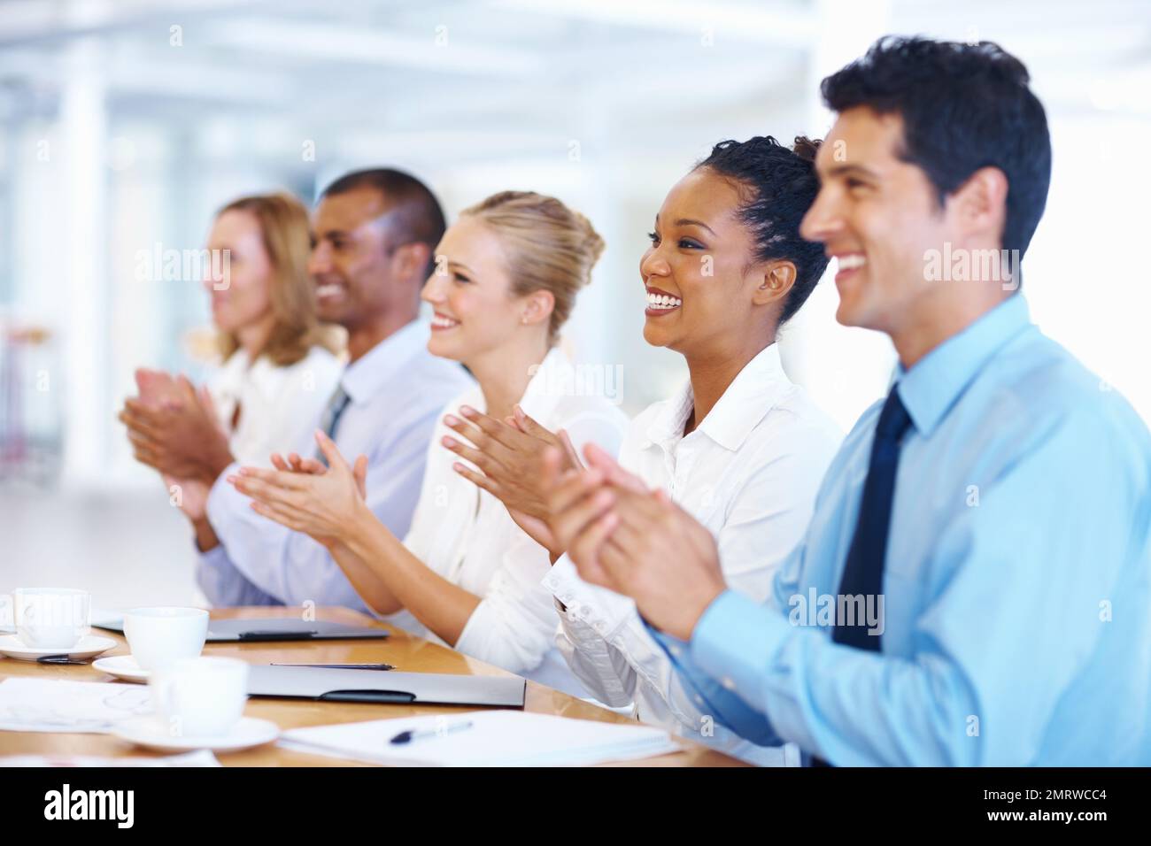 Successful presentation. Portrait of multi racial executives clapping after successful presentation. Stock Photo