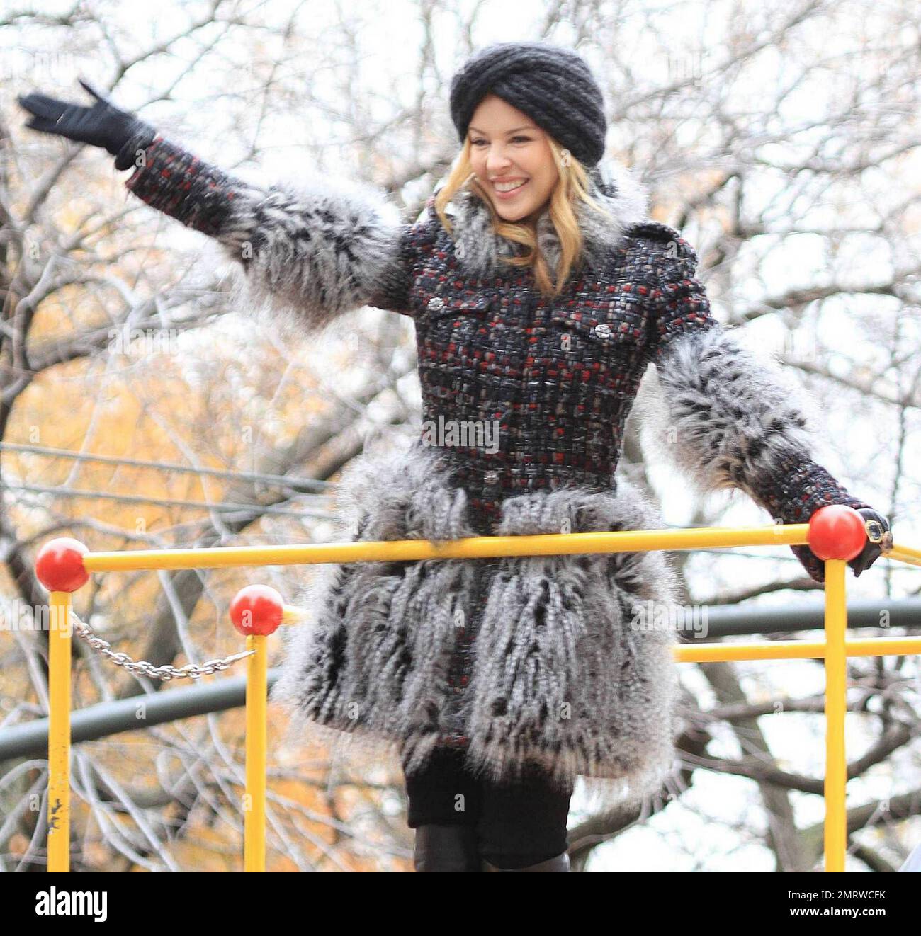 Looking very happy and warm Kylie Minogue waves to the crowds from