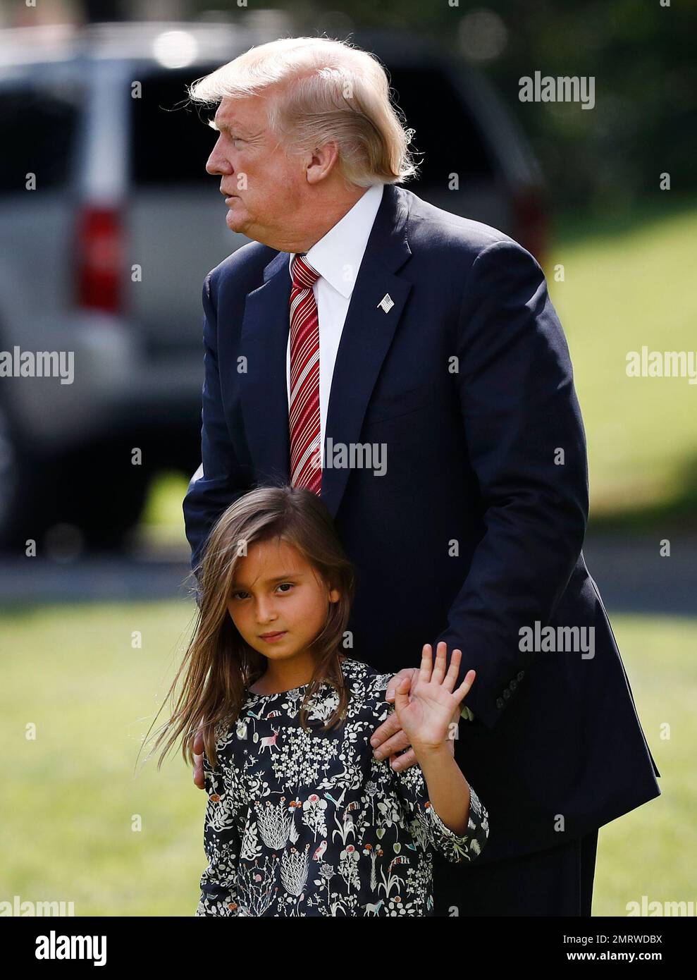 President Donald Trump pauses as he walks with his granddaughter Arabella  Kushner from Oval office of the White House Washington, Friday, Aug. 25,  2017, to Marine One en route to Camp David,, image size:989x1390