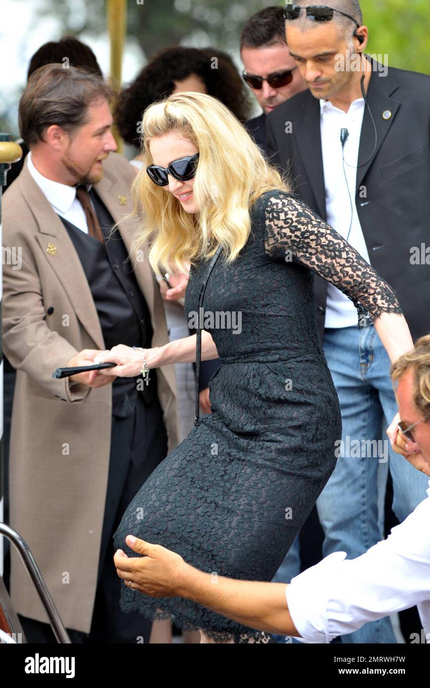 USA ONLY Madonna wears a black lace dress as she gets on a boat while heading to the Gucci party prior to the premiere of A Dangerous Method while in Italy