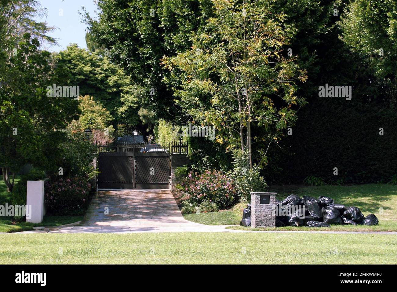 Exclusive!!  Looks like material girl  Madonna had a spring clean but then  missed trash day and had to dump her garbage on the road outside her 90210 mansion. Beverly Hills, Ca. 4/7/06 Stock Photo