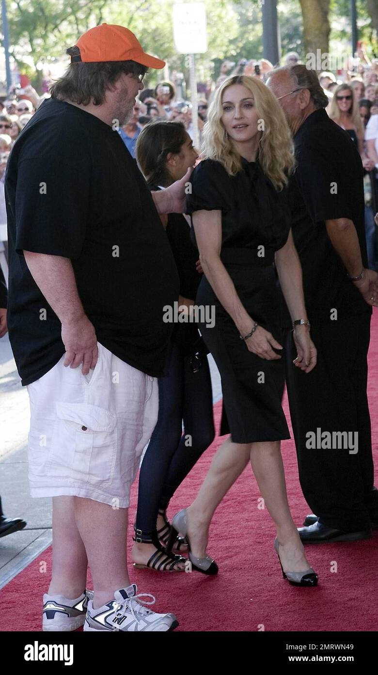 Madonna and Michael Moore arrive at the State Theatre for the screening of her movie 'I Am Because We Are' during the Traverse City Film Festival.  The documentary looks at Malawi's 1 million plus orphans in the wake of the AIDS pandemic. It offers hope and real solutions to the challenges that people face living in extreme poverty. It was written by Madonna and directed by Nathan Rissman. Traverse City, Michigan. 8/2/08 Stock Photo