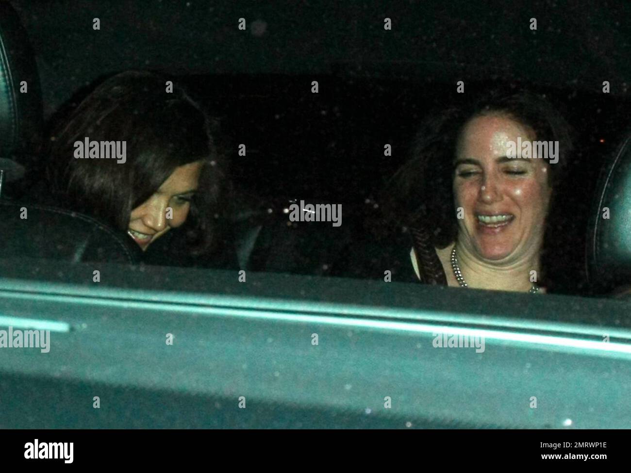 Actress Maggie Gyllenhaal laughs with a friend after dining at Madeo restaurant. Los Angeles, CA. 02/15/10.   . Stock Photo