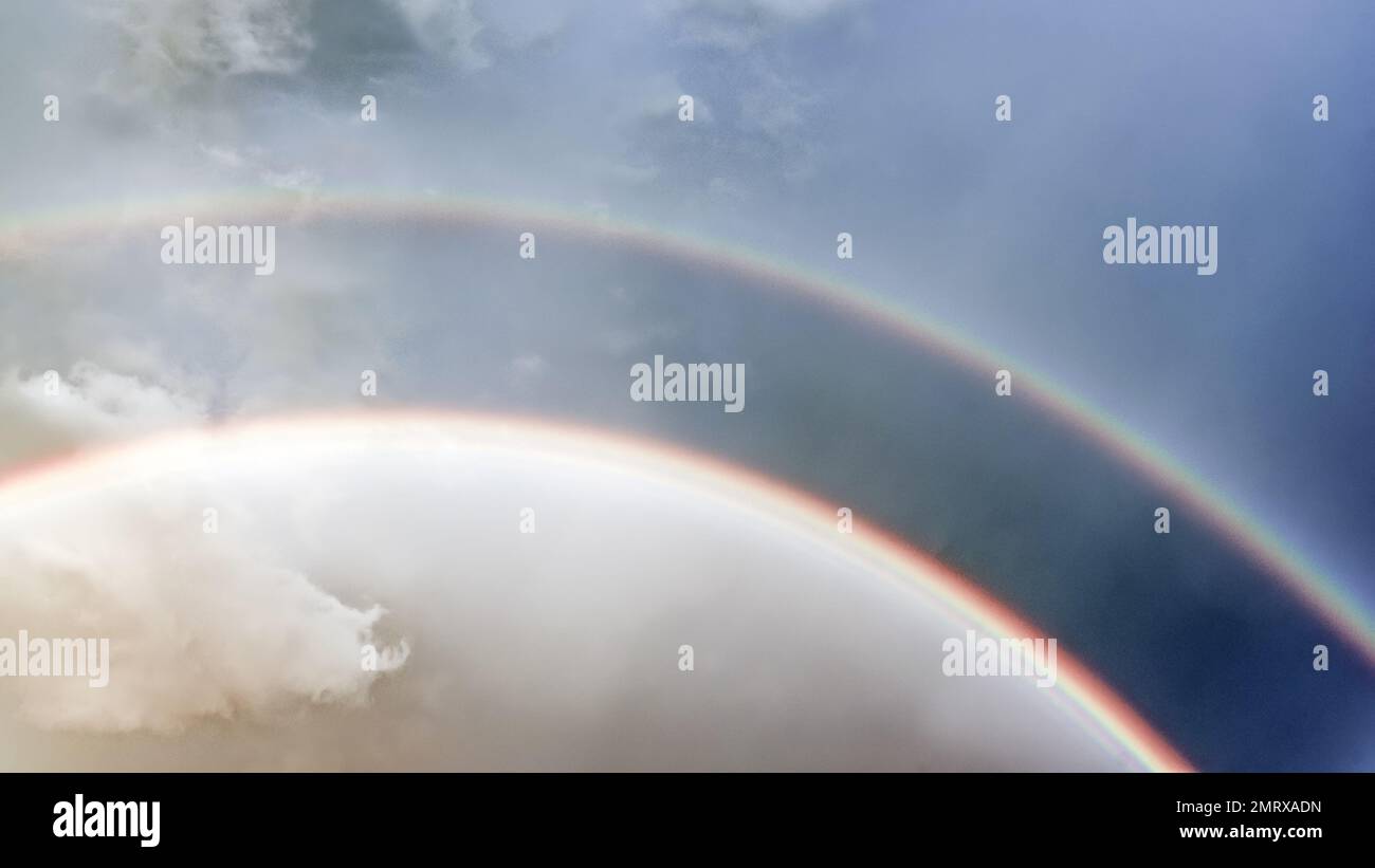 Double rainbow after rain during the day against the background of white clouds Stock Photo Alamy