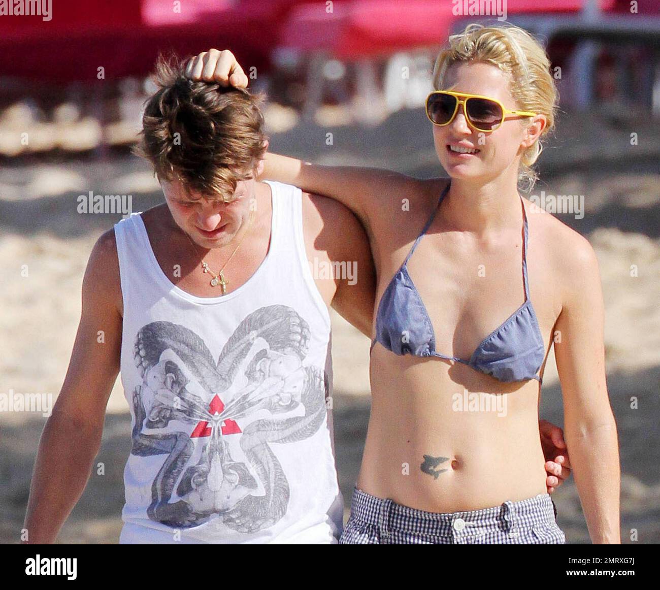 Take That singer Mark Owen and wife Emma Ferguson enjoy a romantic barefoot morning stroll on the beach while continuing their holiday in the Caribbean.  In a white sleeveless shirt and shorts Mark held hands with Emma, clad in tiny shorts and a bikini top, and later wrapped his arm around her shoulders.  Looking very much in love Emma kissed Mark on the shoulder and played with his hair.  Later the pair stopped so Mark could pose for a picture with a young fan. Owen and his fellow Take That band members, Gary Barlow, Howard Donald and Jason Orange, are reportedly on the tropical island to per Stock Photo