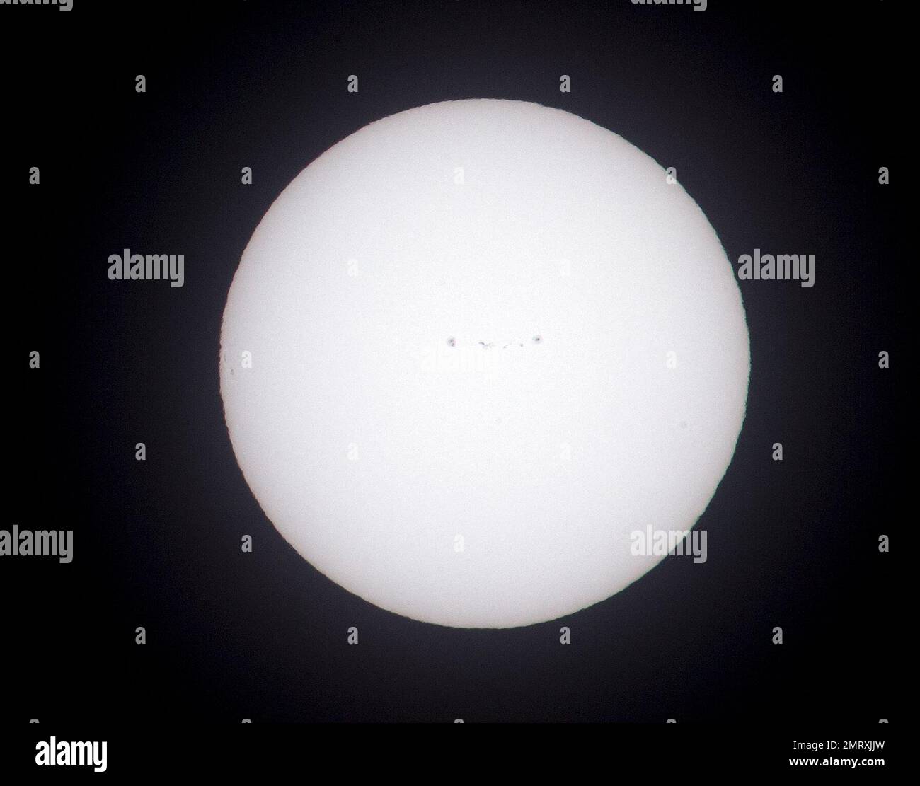 The sun, shown here shot through a white light solar filter, shows a ...
