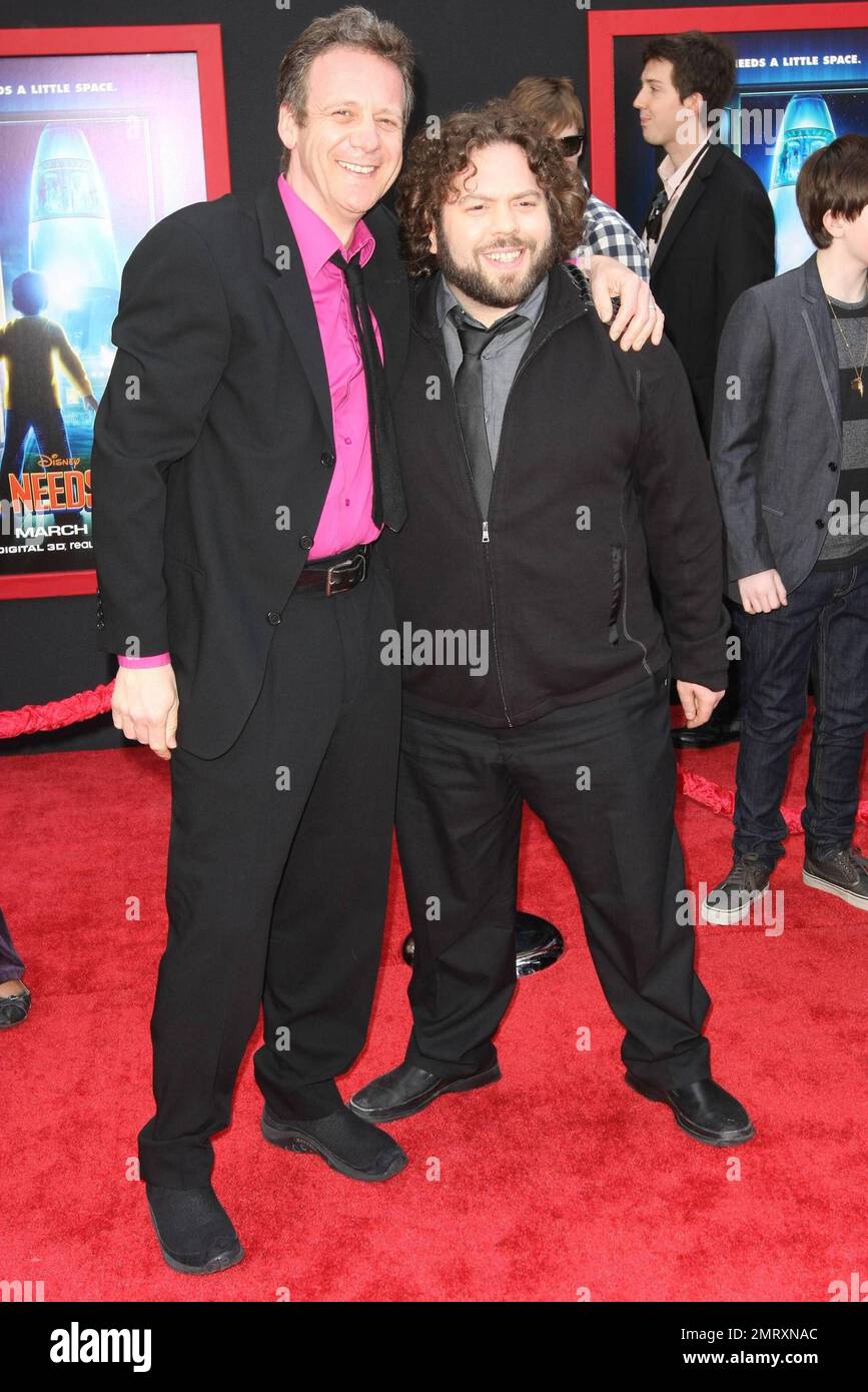 Simon Wells and Dan Fogler pose for photographers on the red carpet at