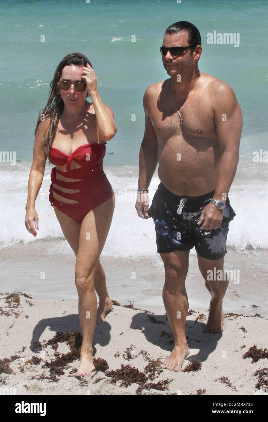 'The Real Housewives Of Miami' star Marysol Patton and a male friend enjoy the beach and ocean. Miami Beach, FL. 28th of May, 2012. Stock Photo