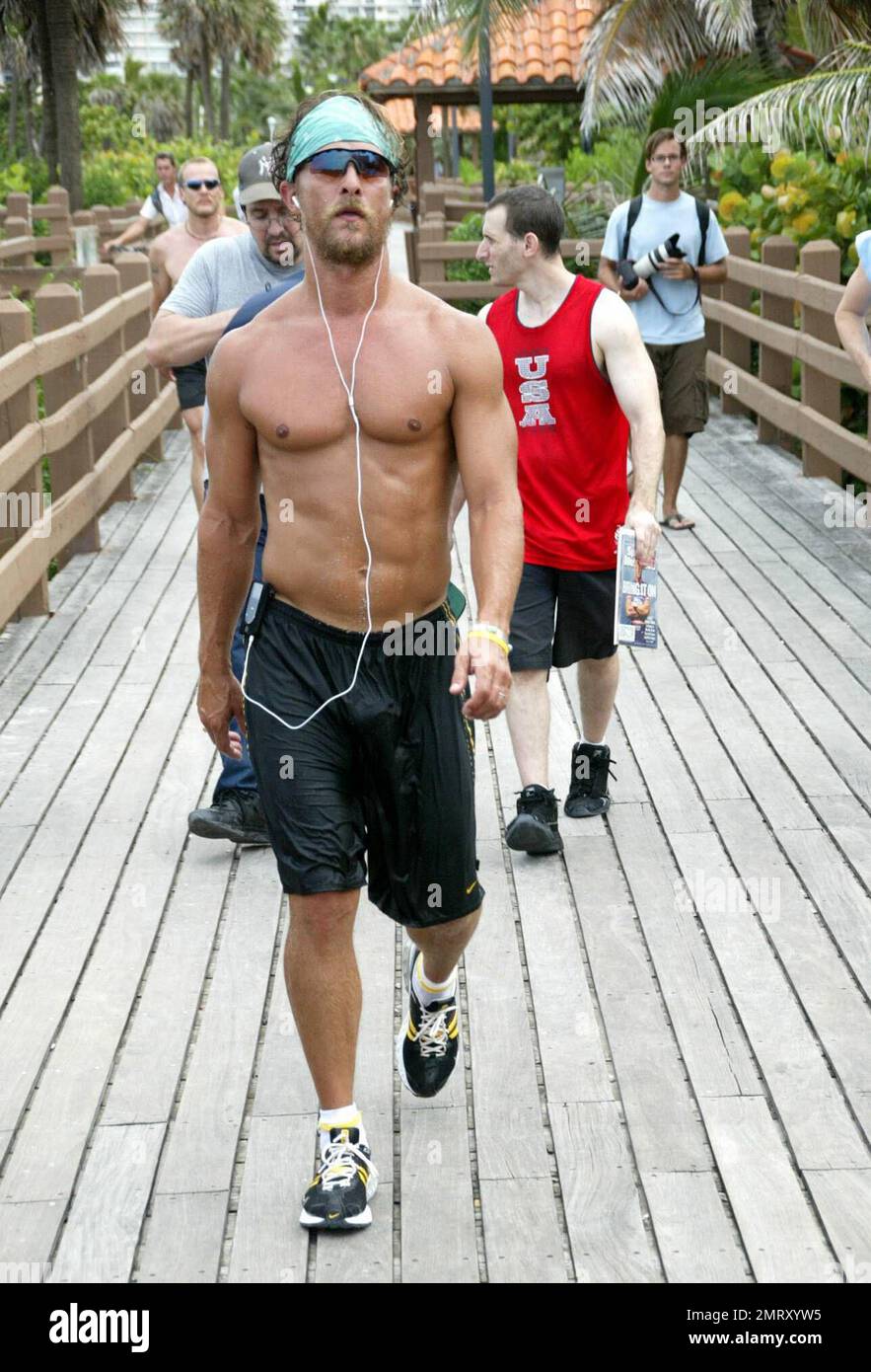 Matthew McConaughey warms up for his beach workout by getting down to some tunes on his iPod. After jogging with pal Lance Armstrong, he walked the boardwalk to the nearest refreshments, followed by local photographers who struggled to keep up, Miami Beach, FL, 8/23/06 Stock Photo